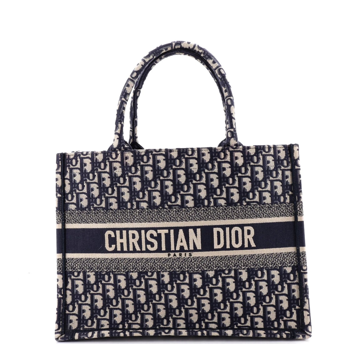 Christian Dior Book Oblique Medium Canvas Tote: Christian Dior Book Oblique Medium Canvas Tote The Christian Dior Book Oblique Medium Canvas Tote boasts a striking blue exterior with minor creases, corner wear, and discoloration. This excellent con