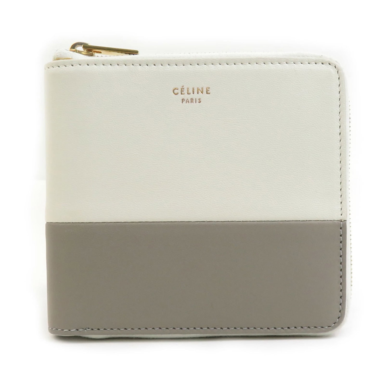 Leather Bi Fold Wallet: Leather Bi Fold Wallet The Celine Leather Bi Fold Wallet features a sleek, gray design with an ivory accent, crafted from high-quality Italian leather. Measuring 10cm x 11cm x 2cm, it offers a compact