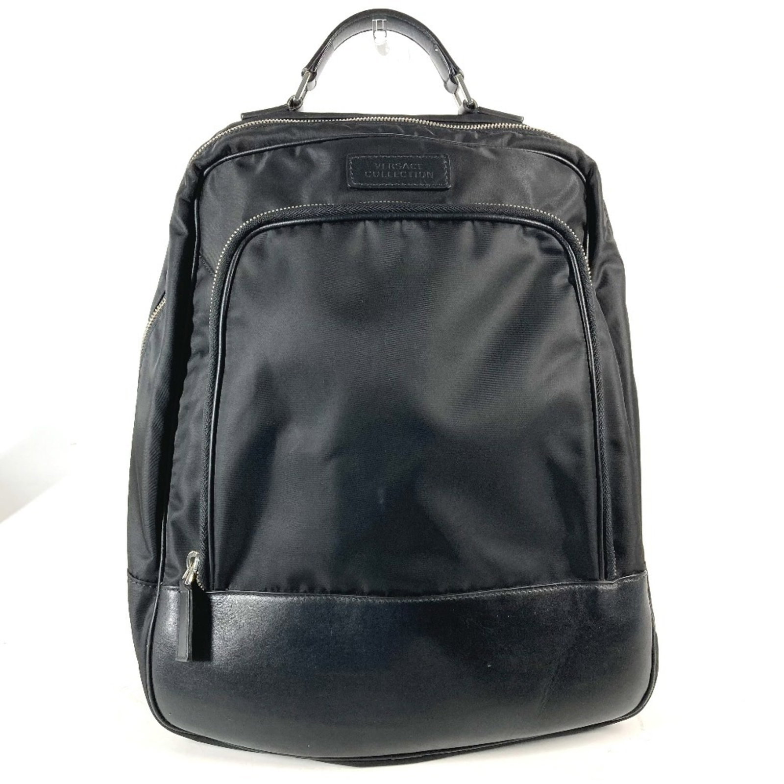 Nylon Leather Versace Backpack: Nylon Leather Versace Backpack Versace Nylon Leather Backpack in Black. This backpack features a unique combination of nylon and leather materials, with a sleek black design that showcases the iconic