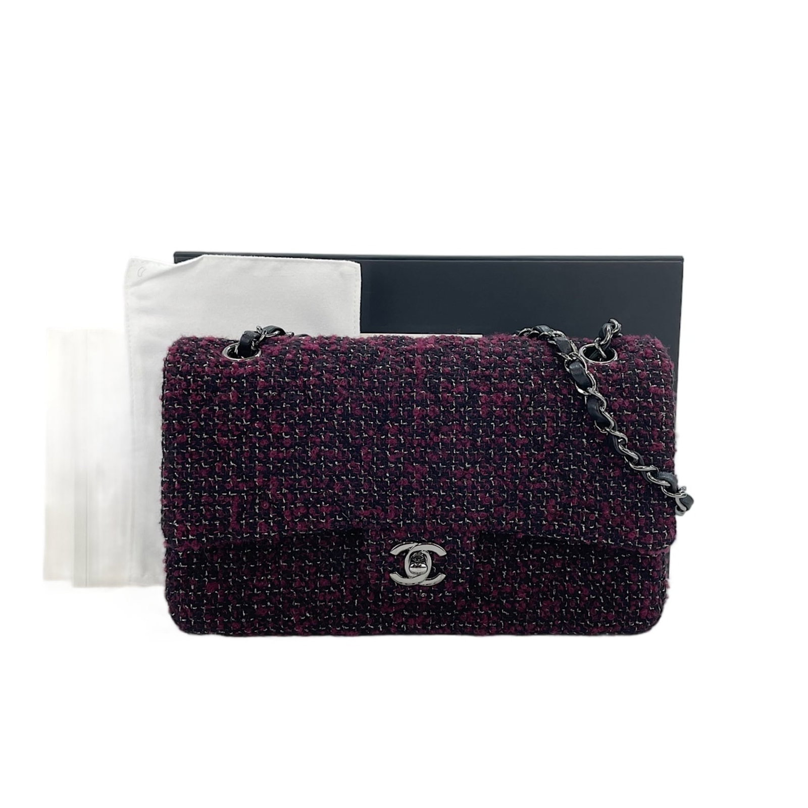 Shoulder Bag by Chanel: Shoulder Bag by Chanel Wine-colored shoulder bag from iconic French fashion house Chanel, measuring 15cm x 25cm x 6cm. This sleek and stylish design showcases the brand's signature elegance, with clea