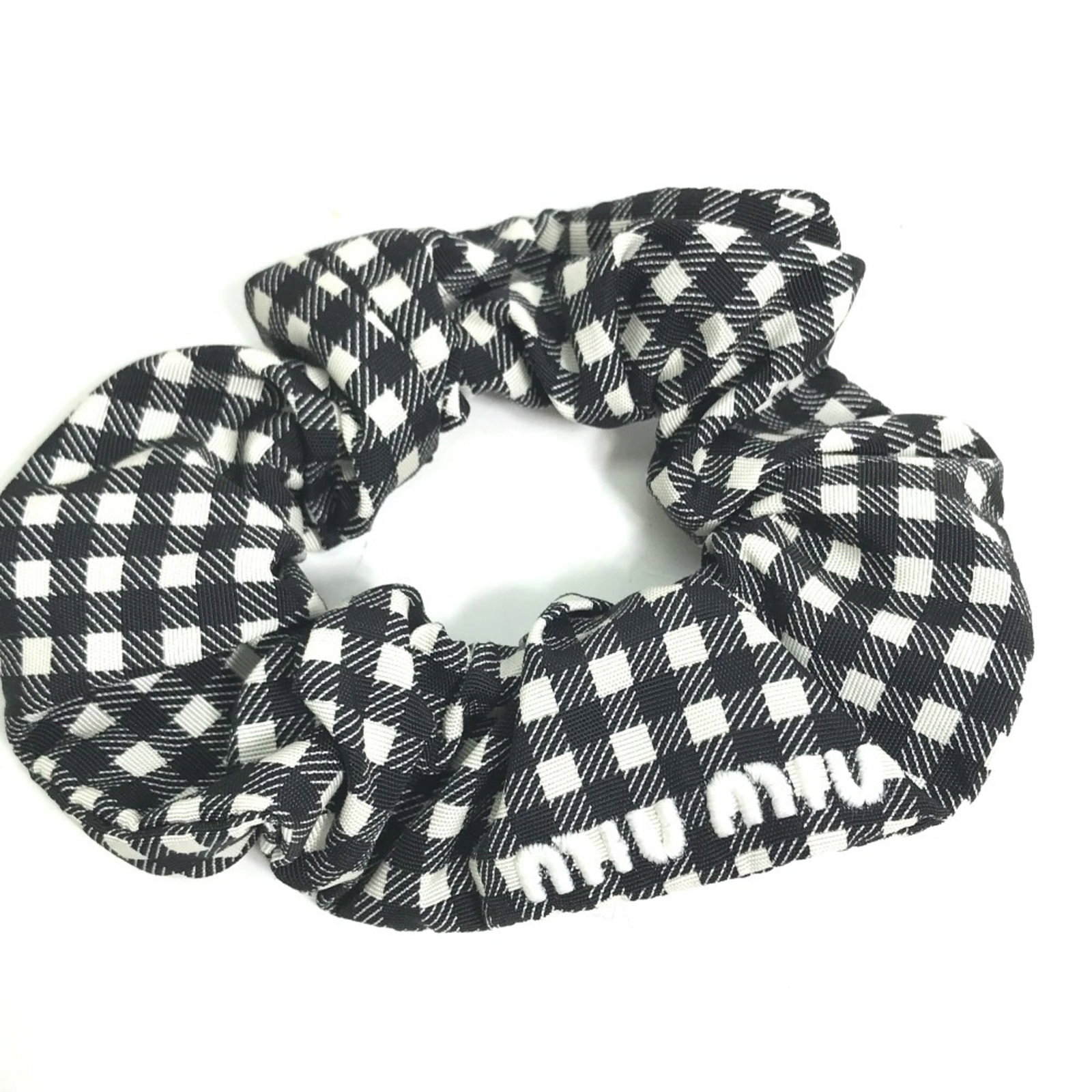Nylon Scrunchie Miu: Nylon Scrunchie Miu Black and White Nylon Scrunchie Miu. This nylon scrunchie features a sleek design with a signature, bears a signature, and comes in two colors: black and white. It arrives in a box
