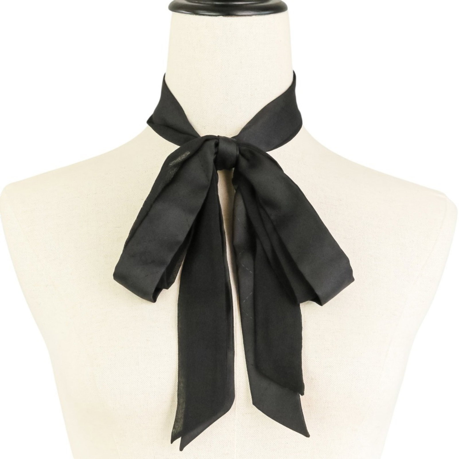Chanel Silk Scarf: Chanel Silk Scarf Silk in its finest form, this black Chanel scarf boasts a sleek and sophisticated design. Made from high-quality silk, it measures 1.55m x 3cm, perfect for adding a touch of elegance