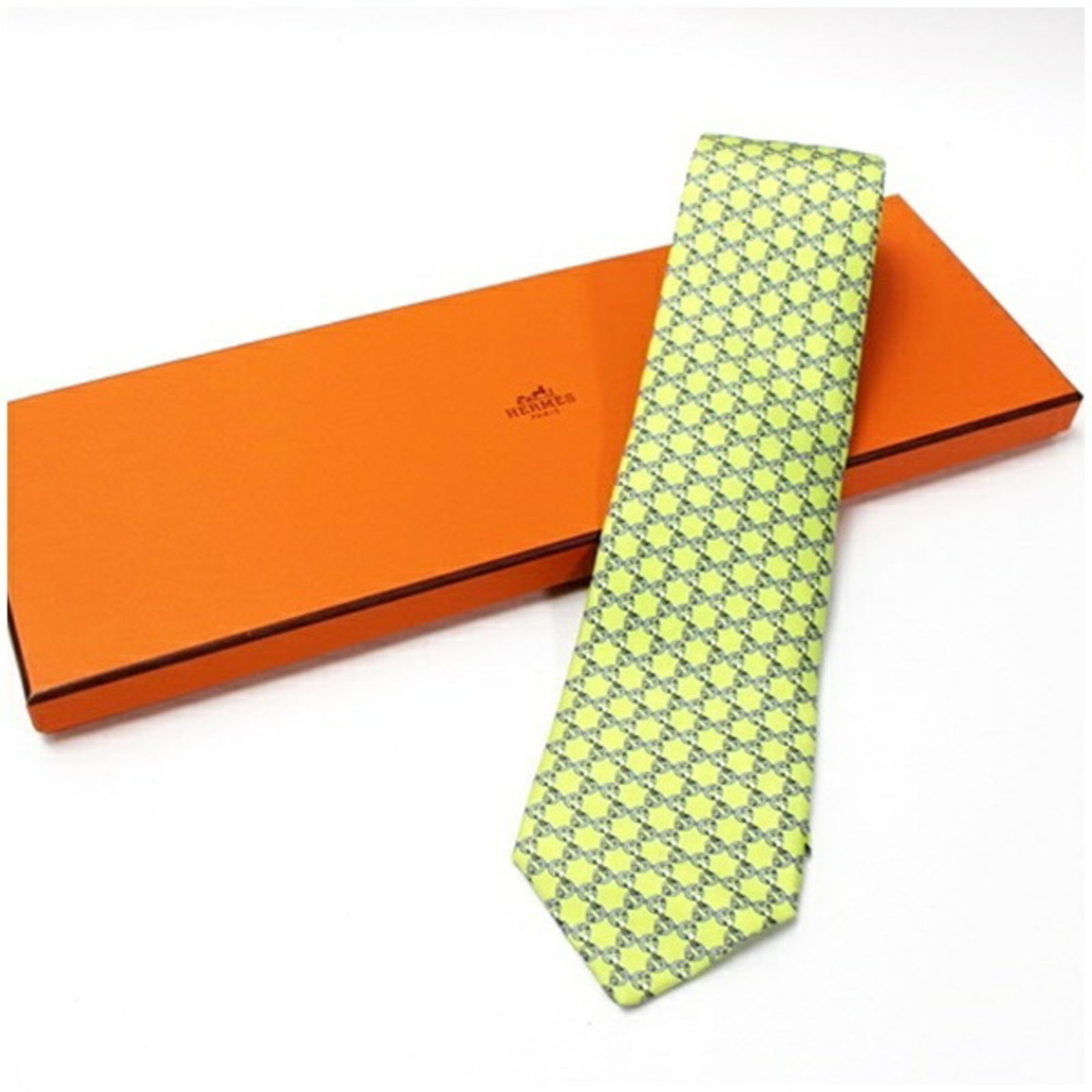 Hermes Cravat Silk: Hermes Cravat Silk Gray and light green cravat made from high-quality silk, measuring 8cm in width. This elegant accessory bears a signature, adding a touch of sophistication to any outfit. Made by th