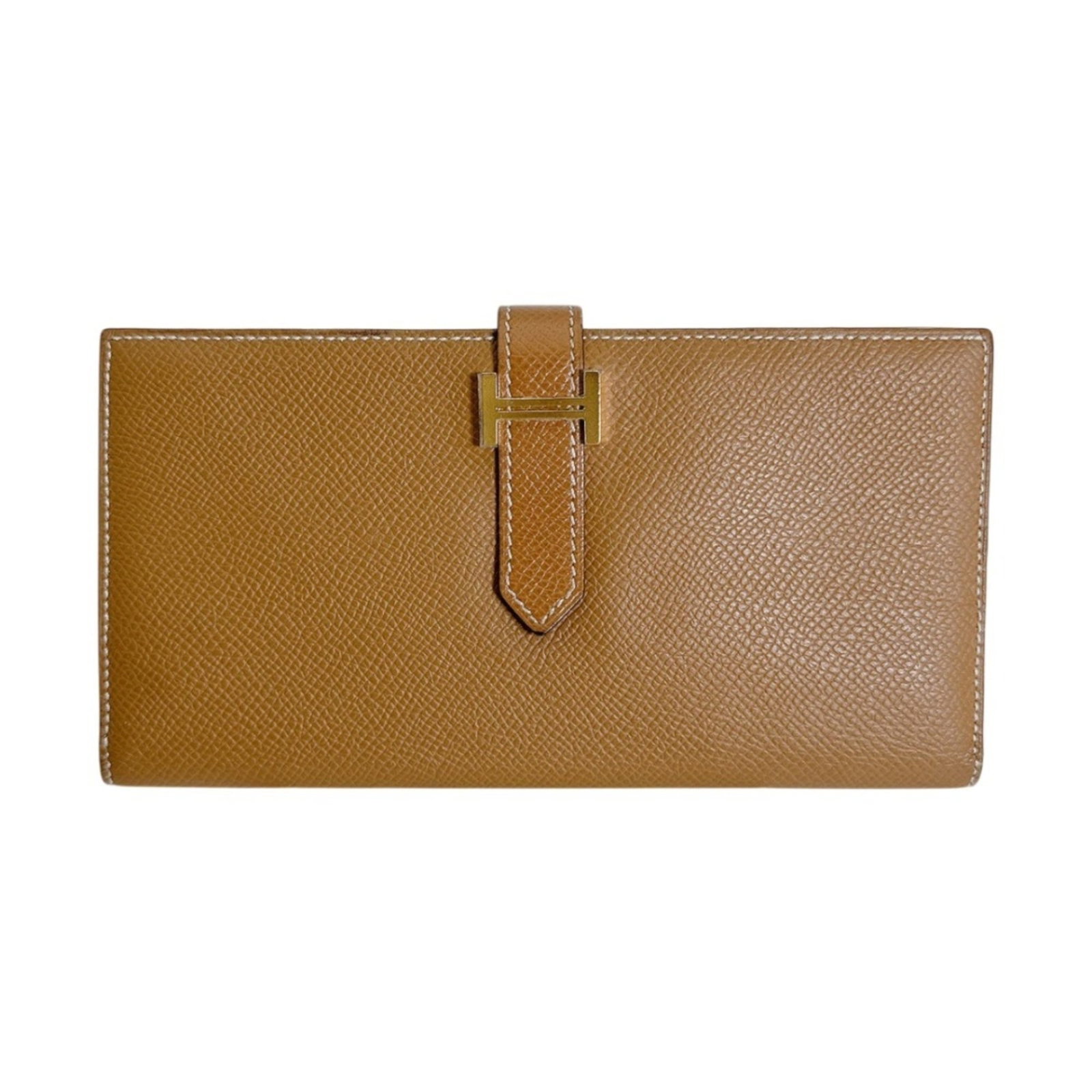 Epsom Leather Bi Fold Wallet Hermes: Epsom Leather Bi Fold Wallet Hermes Epsom Leather Bi Fold Wallet by Hermes features rich, brown Epsom leather construction with a classic bi-fold design. The wallet measures 9.5cm x 17.5cm x 1.5cm and