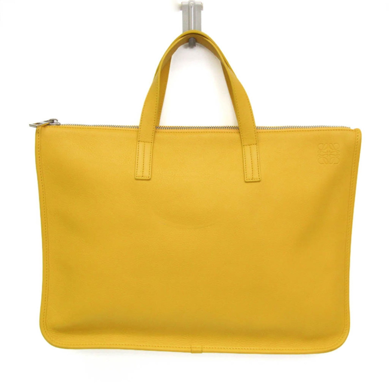 Briefcase leather handbag by Loewe: Briefcase leather handbag by Loewe The Loewe Anagram Briefcase Leather Handbag features a striking yellow color and premium leather material. With its unique design, the bag boasts two functional