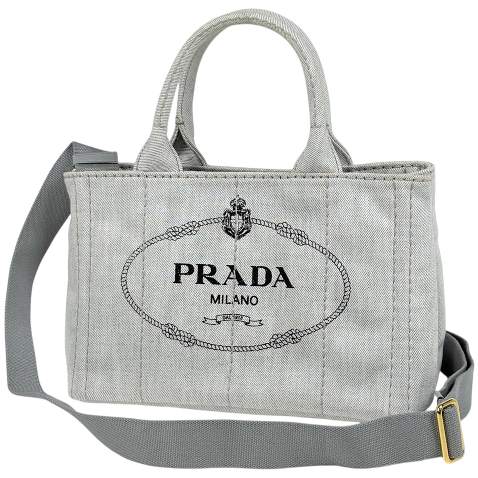 Denim Tote Bag Prada: Denim Tote Bag Prada White Denim Tote Bag from Prada, measuring 19cm x 28cm x 15cm. This classic tote features a durable denim material and a timeless design that makes it a versatile accessory for