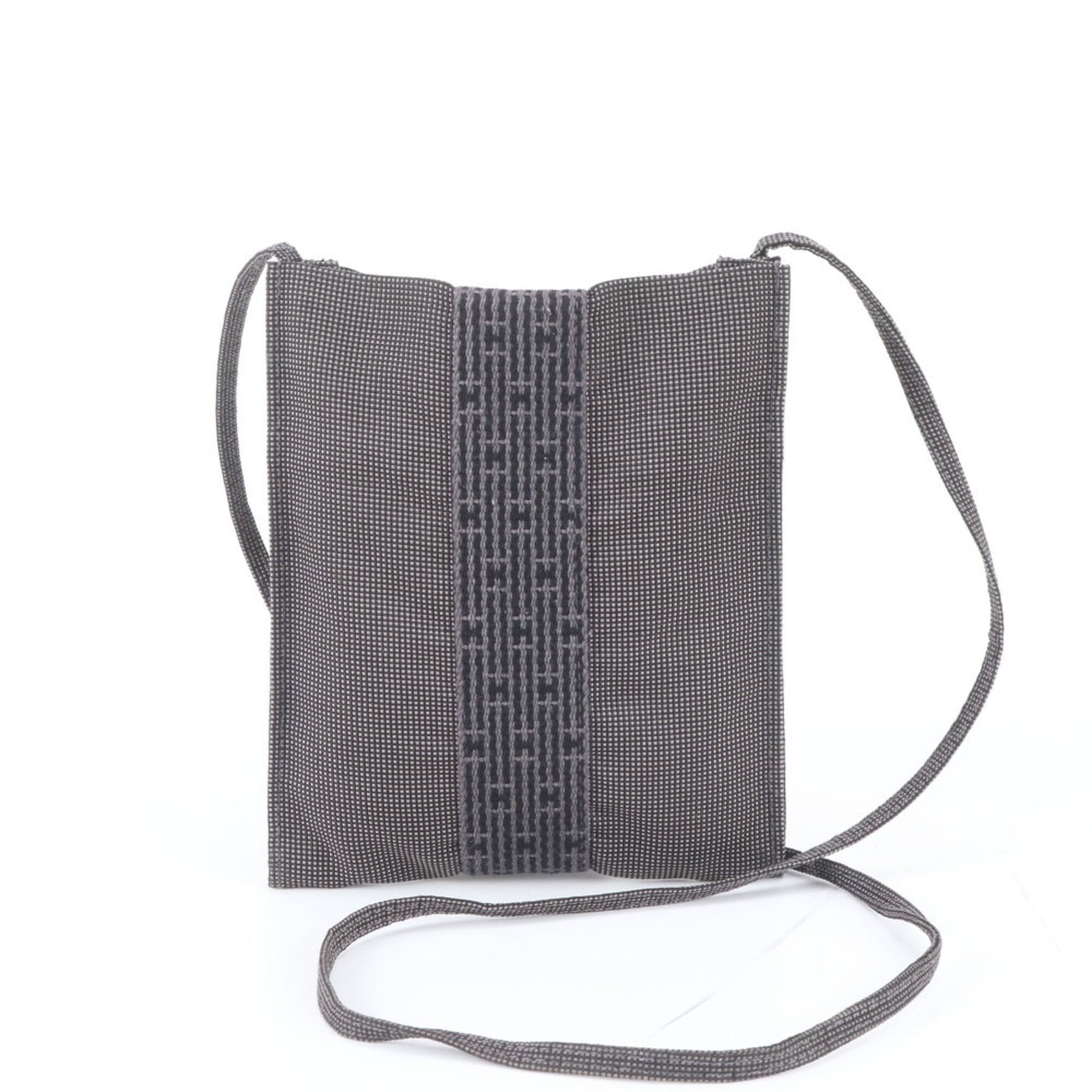 Hermes Pochette Shoulder Bag Canvas: Hermes Pochette Shoulder Bag Canvas Canvas Pochette Shoulder Bag from Hermes' Her Line, crafted in France with a sleek black design and adjustable 120cm strap. Measuring 20cm x 17cm x 1cm, this
