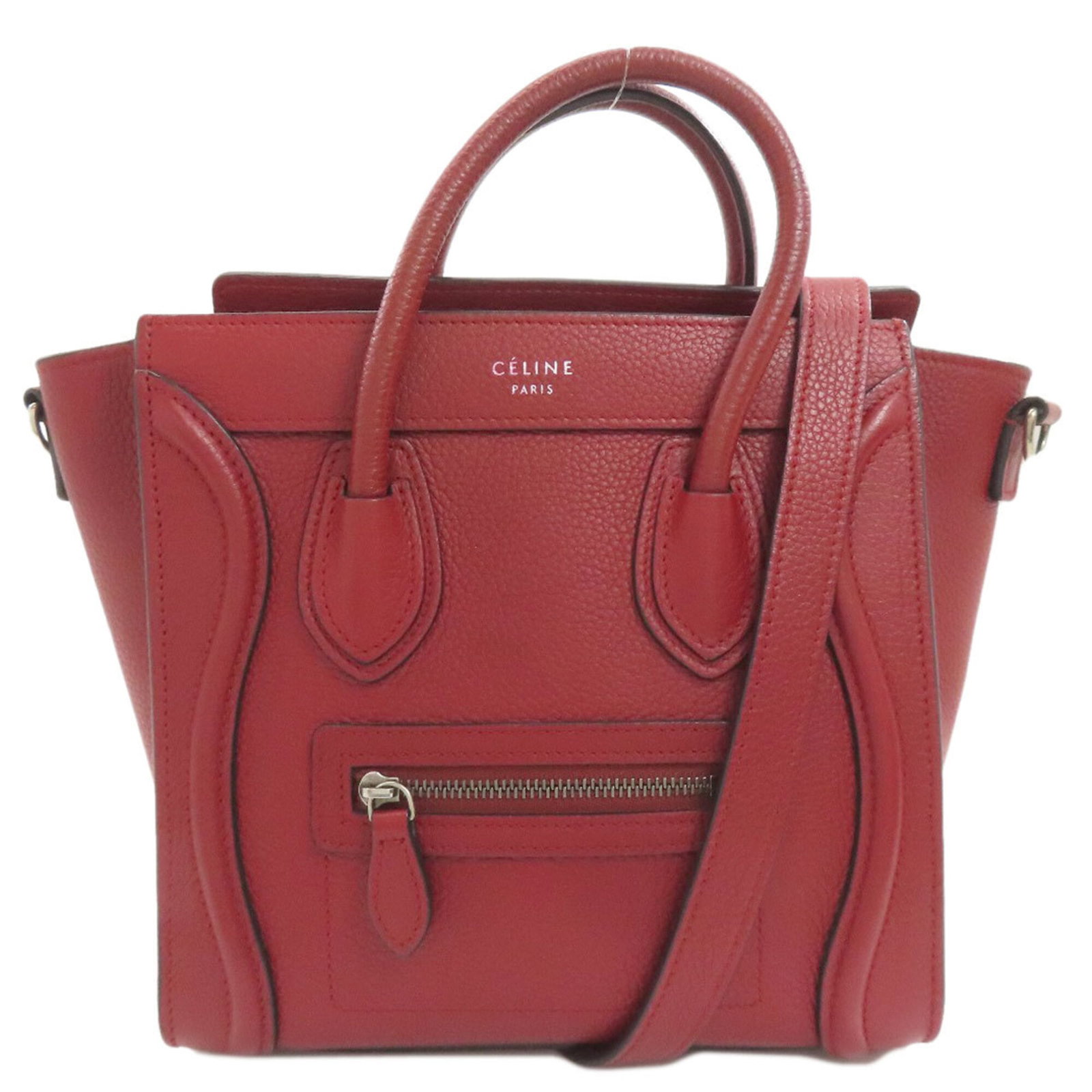 Handbag Celine Leather: Handbag Celine Leather Red Celine Leather Handbag. Made from high-quality leather, this handbag features a distinctive red color and a zipper closure. Measuring 21cm x 28.5cm x 9.5cm, it has a sturdy 