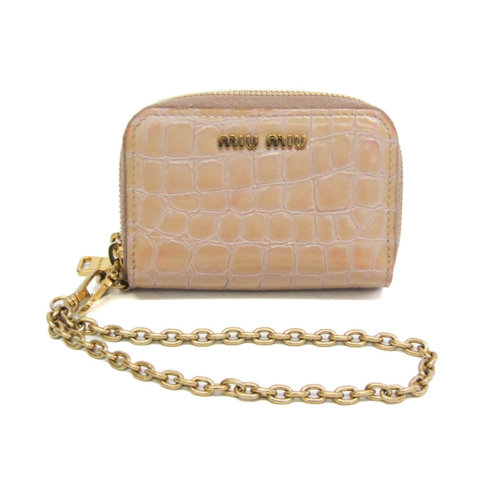Case card leather miu: Case card leather miu Card case in embossed calf leather with a zipper closure, featuring an outer coin purse and inner card holder. The pink beige color adds a touch of elegance to this compact