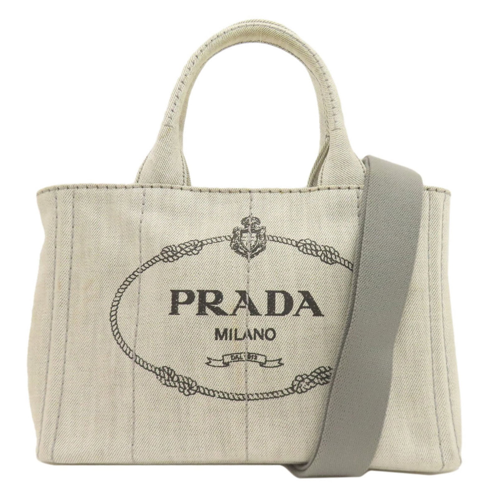 Handbag Canvas by Prada: Handbag Canvas by Prada Light gray canvas handbag by Prada, measuring 18.5cm x 28.5cm x 15cm, features a sturdy handle and adjustable strap that can be customized to fit your style. The bag's canvas