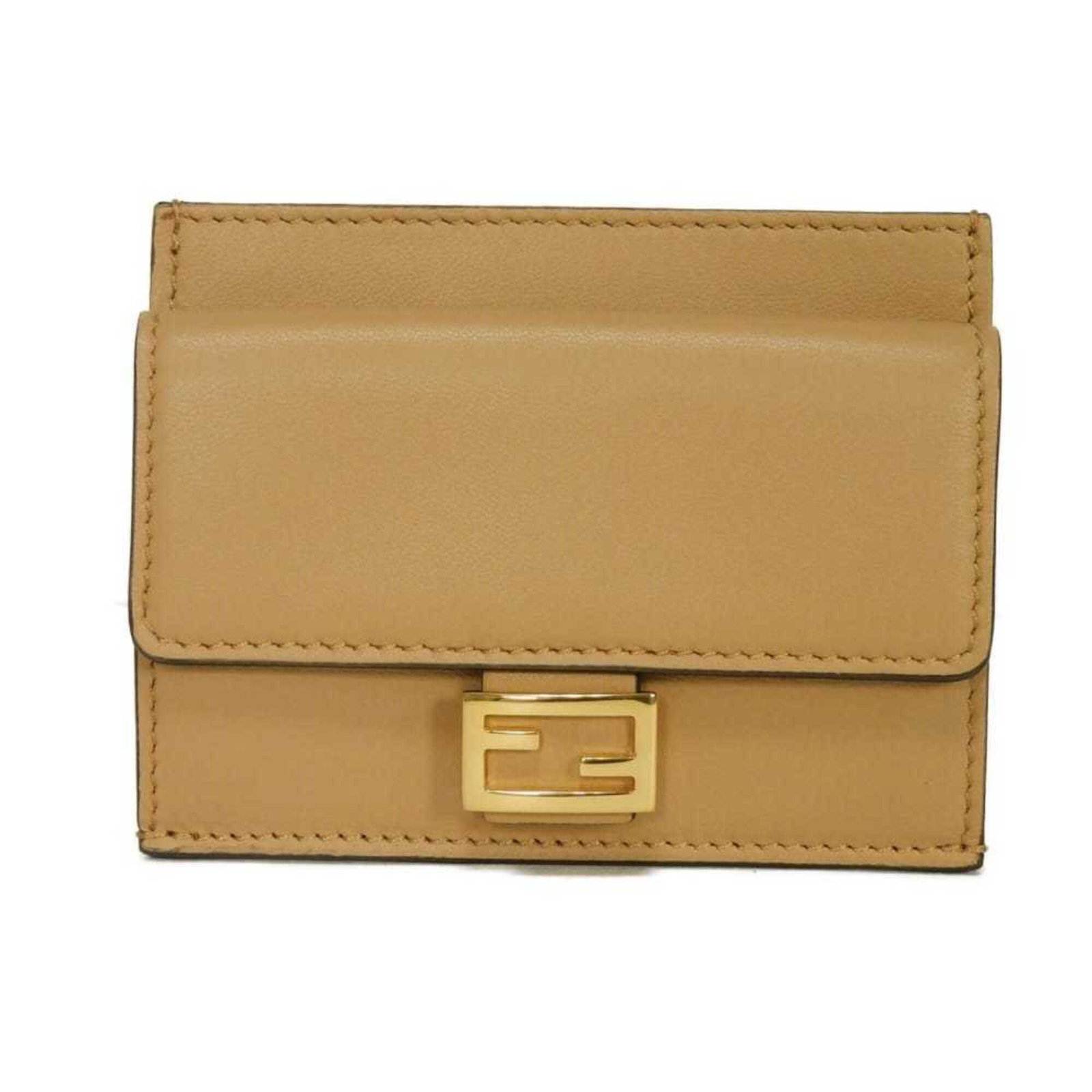 Coin purse leather case by Fendi: Coin purse leather case by Fendi The Fendi coin purse leather case boasts sleek, sophisticated design with its lambskin material and classic beige color. Made from high-quality leather, this stylish a