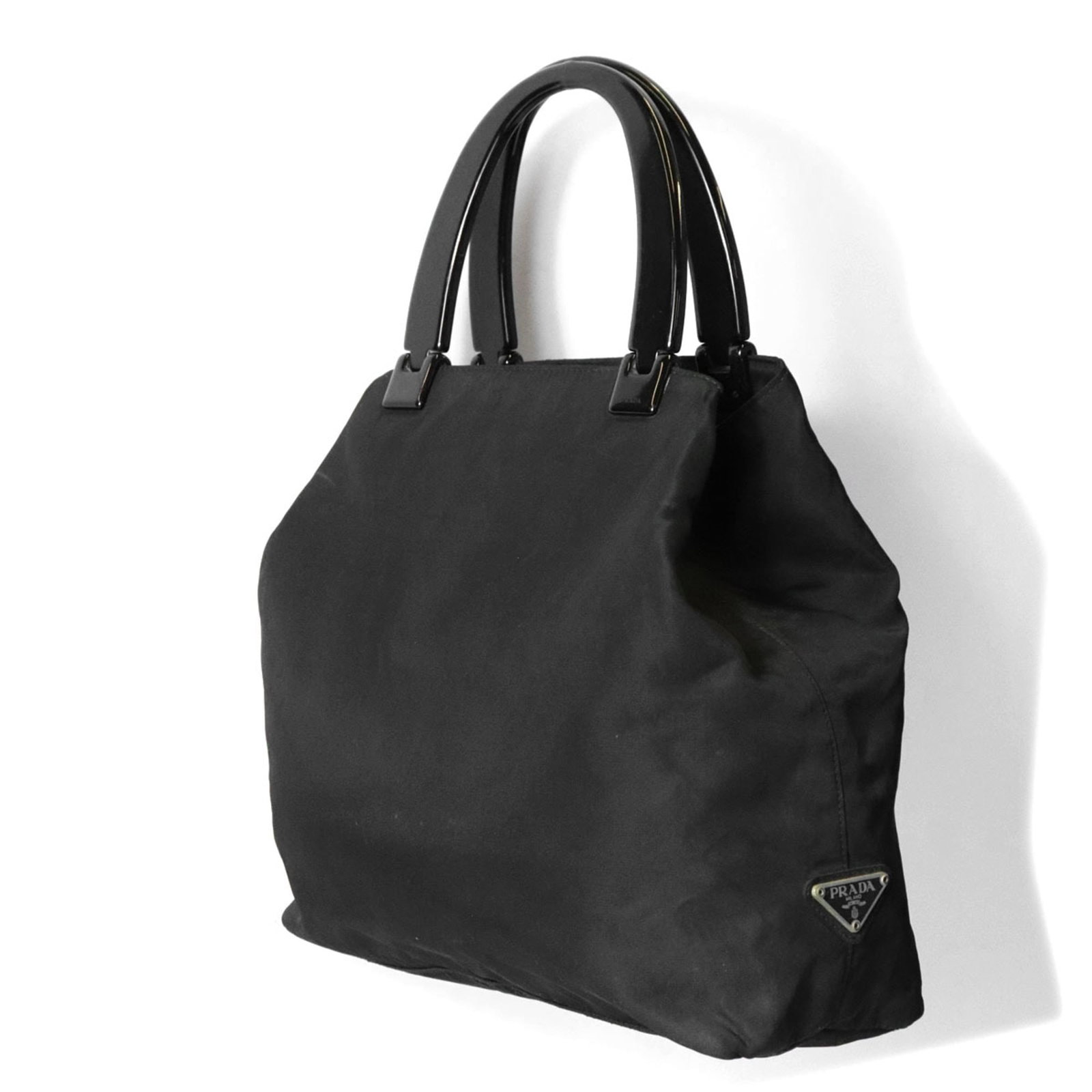Prada Handbag Nylon: Prada Handbag Nylon The Prada Nylon handbag boasts sleek, modern design with its black color and sturdy nylon material. Measuring 27cm x 36cm x 9cm, it offers a spacious interior for daily