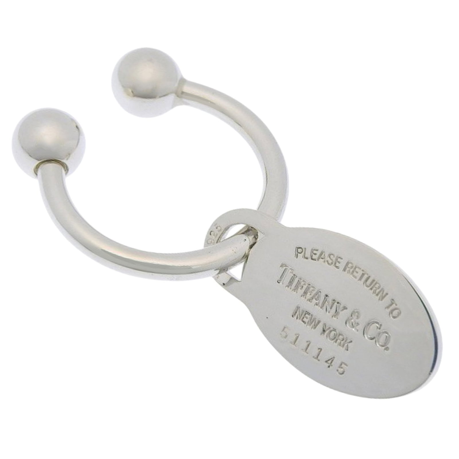 Tiffany silver keyring 925: Tiffany silver keyring 925 Silver Tiffany keyring, made from 925 material, features a sleek design with a signature. The compact size and weight make it easy to carry on keys or as a small accessory.