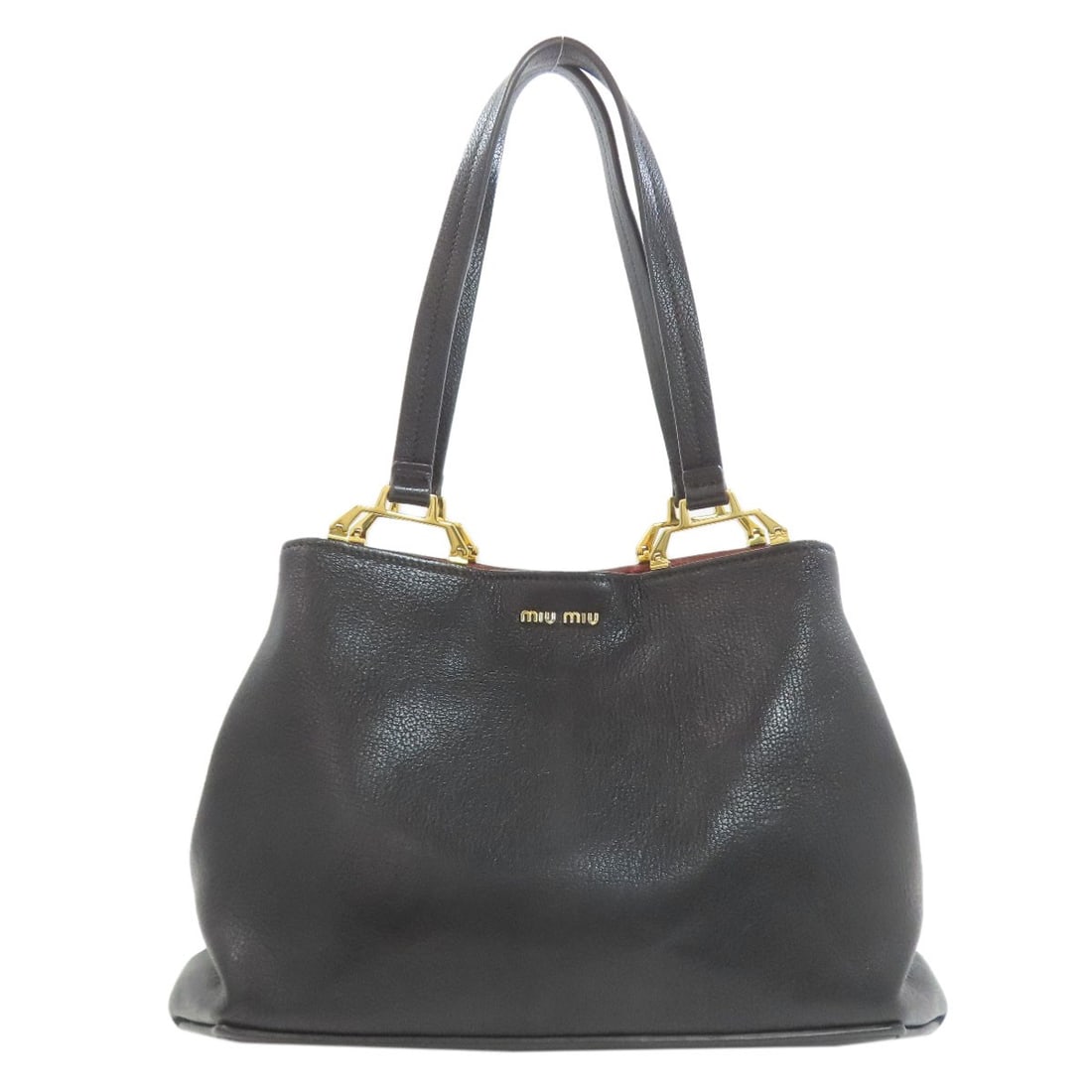 Bag tote leather Madras Miumiu 5Bg025: Bag tote leather Madras Miumiu 5Bg025 Black leather tote bag from MIUMIU, made with high-quality exterior materials. This stylish bag features a classic design and sleek black color, making it a