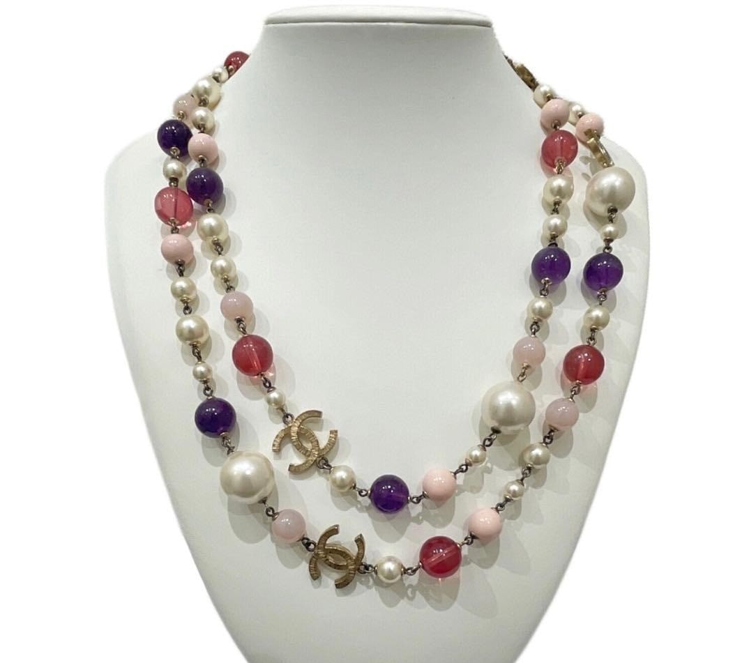 Coco Chanel Mark CC Faux Pearl Colored Stone Long Double Strand Necklace: Coco Chanel Mark CC Faux Pearl Colored Stone Long Double Strand Necklace Item Specifics: Brand: CHANEL Type: Necklace Color: Purple Pink White Style: Necklace Material: Metal Main Stone: Faux Pearl Pr