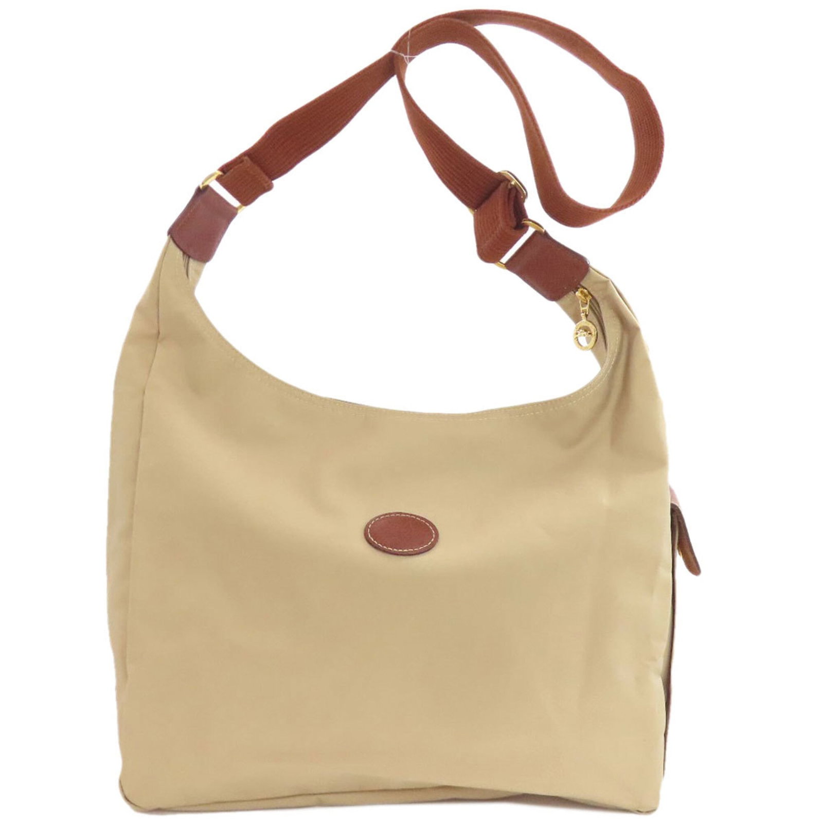 Nylon Longchamp Shoulder Bag: Nylon Longchamp Shoulder Bag The Longchamp Nylon Shoulder Bag boasts a timeless design with clean lines and a classic beige color, making it a versatile accessory for everyday use. Its spacious