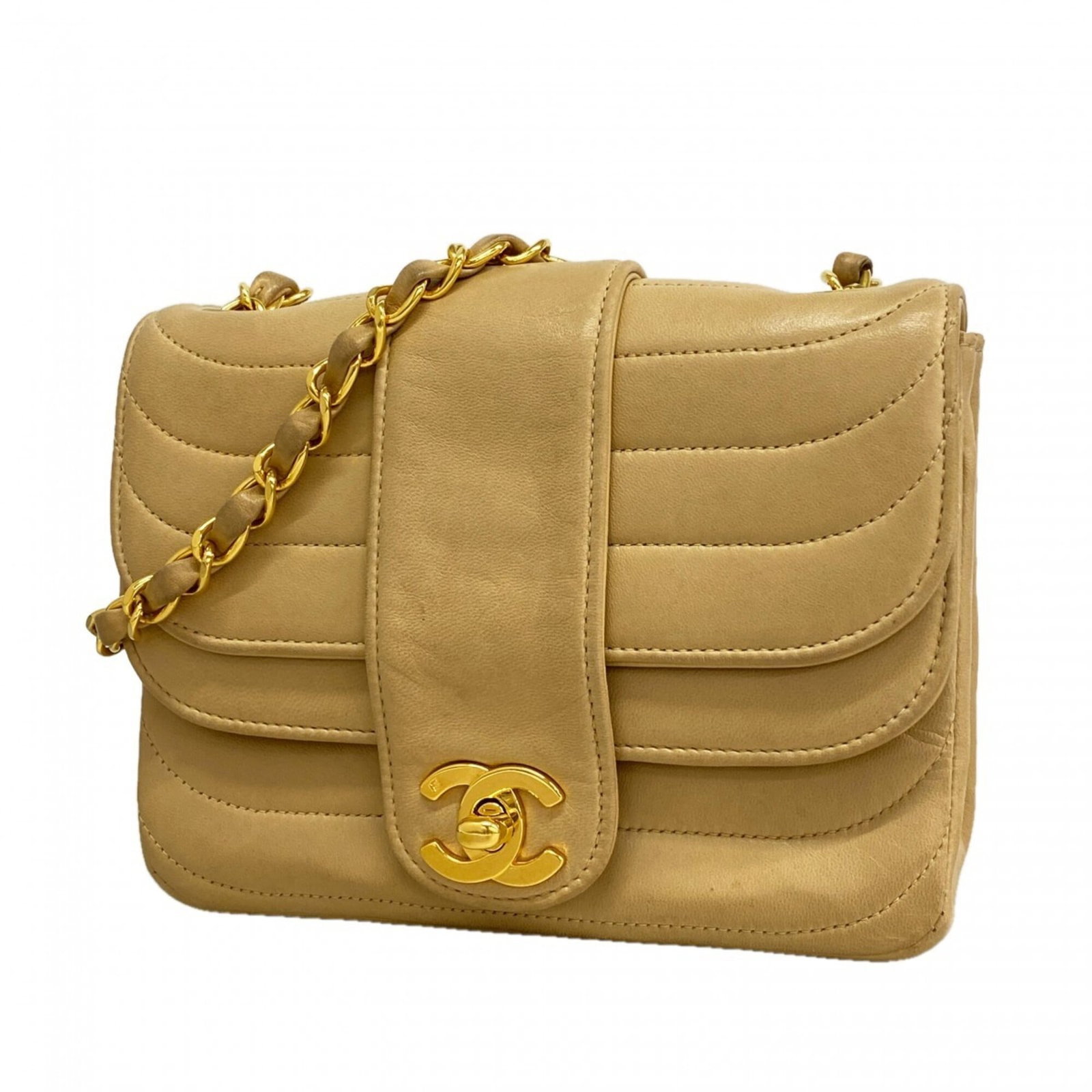 Leather Chanel Shoulder Bag: Leather Chanel Shoulder Bag This classic Chanel shoulder bag boasts a timeless design, crafted from high-quality lambskin leather in a rich beige hue. The elegant gold hardware adds a touch of