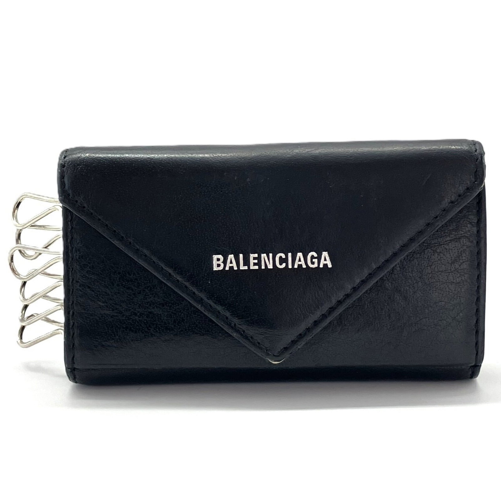 Keycase leather by Balenciaga: Keycase leather by Balenciaga Keycase leather by Balenciaga, featuring six key hooks and made from high-quality black leather. Weighing just 75g, this compact keycase measures 6.5cm x 11cm x 1cm. A