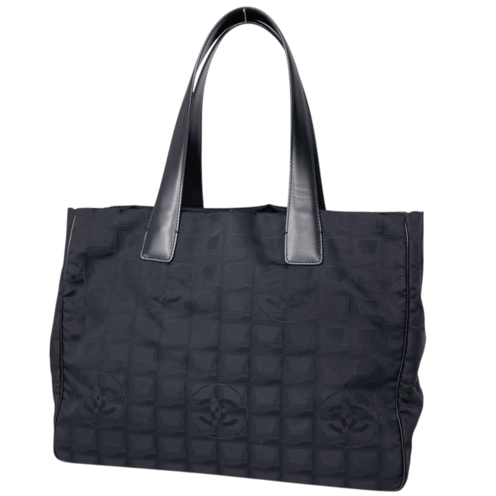 Nylon Leather Chanel Tote Bag: Nylon Leather Chanel Tote Bag Nylon and leather blend creates a unique look in this Chanel tote bag, available in black. Measuring 27cm x 34cm x 15cm, it offers a compact size perfect for daily use.