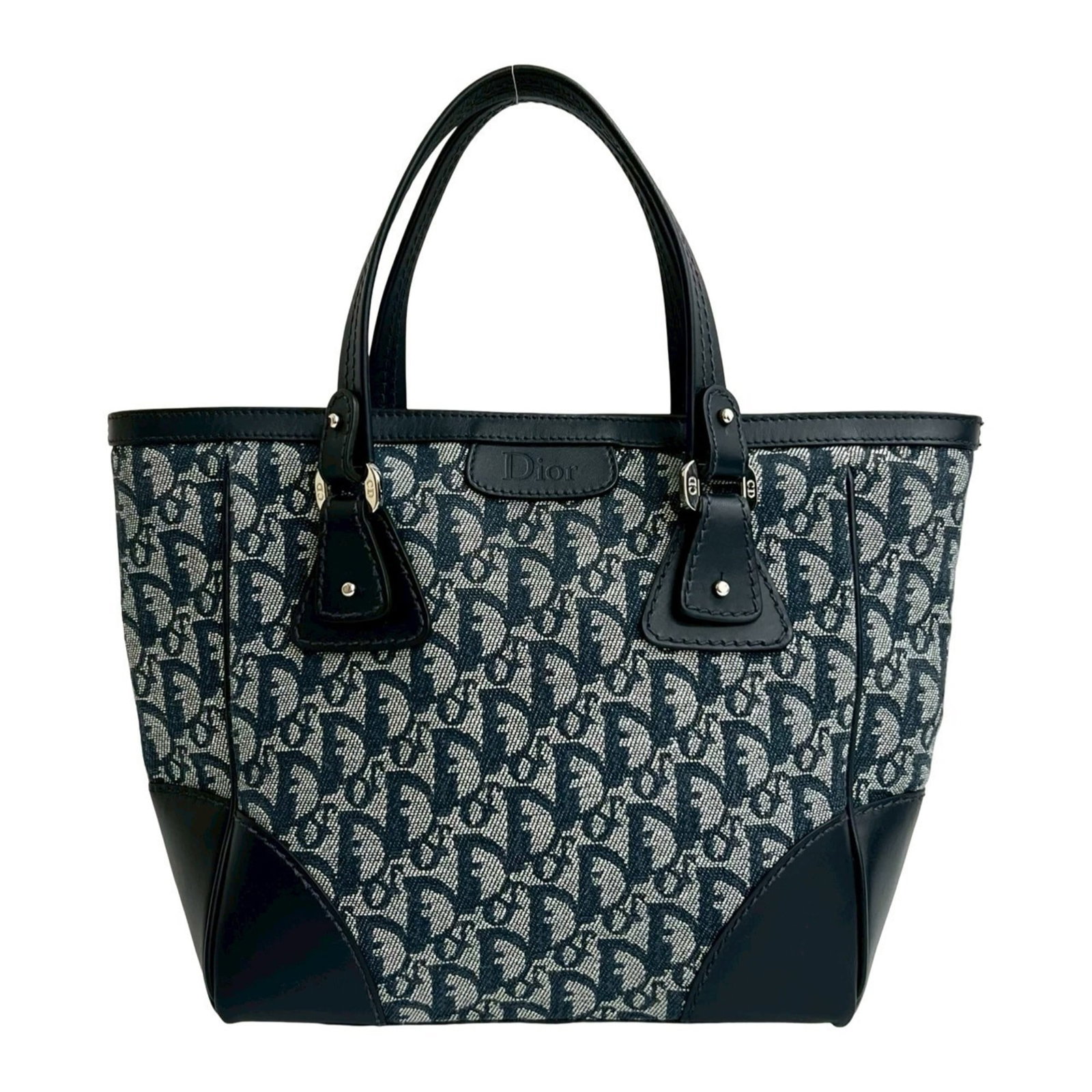 Christian Dior Handbag Canvas Leather Tote: Christian Dior Handbag Canvas Leather Tote Canvas and leather combine in this navy Christian Dior handbag tote, measuring 24cm x 23.5cm x 8cm. The canvas material provides a sturdy base, while the
