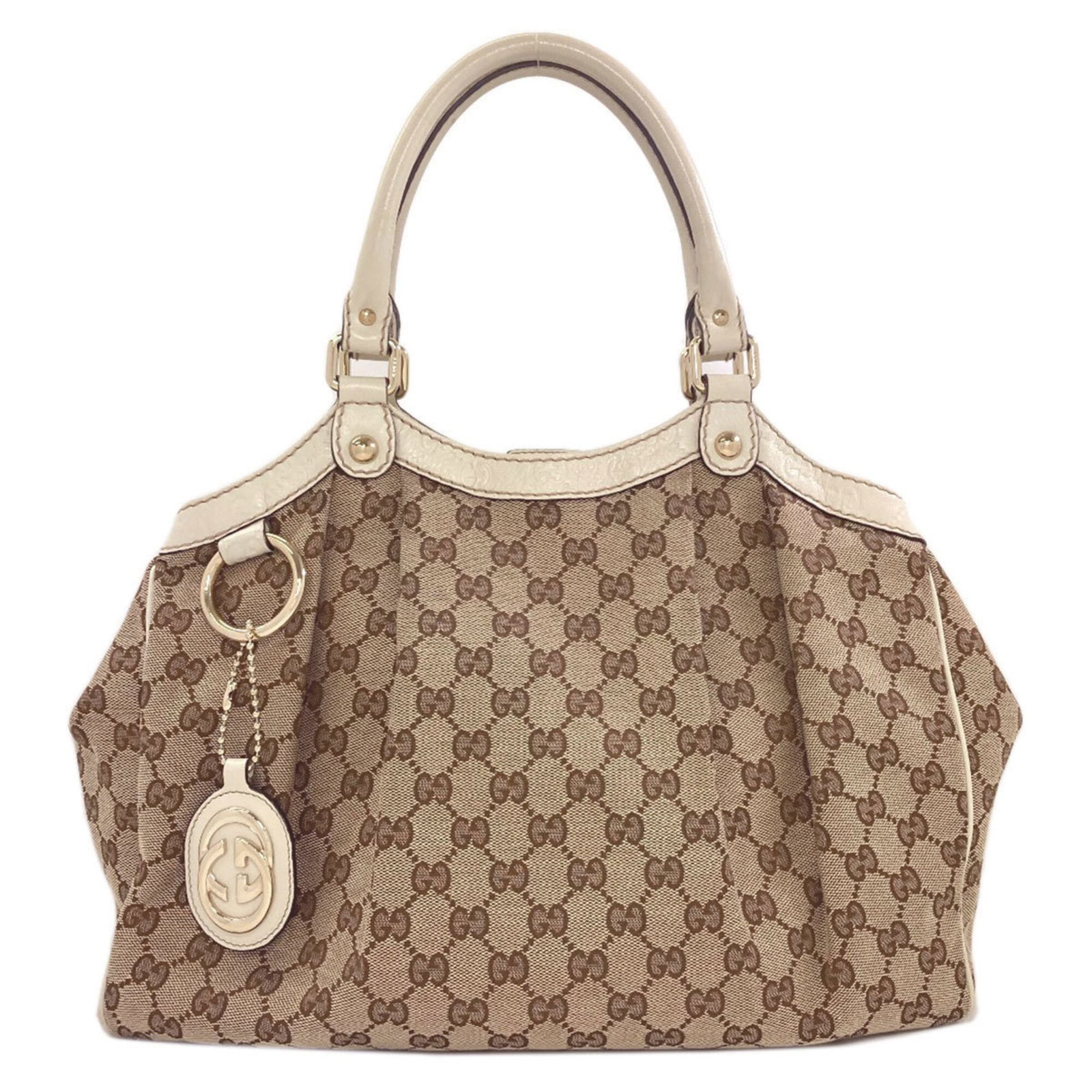 Canvas tote bag by Gucci: Canvas tote bag by Gucci Canvas tote bag by Gucci, featuring brown canvas material and a signature. This stylish tote measures 29.5cm x 34.5cm x 11cm and has a handle length of 30.5cm, making it a pra