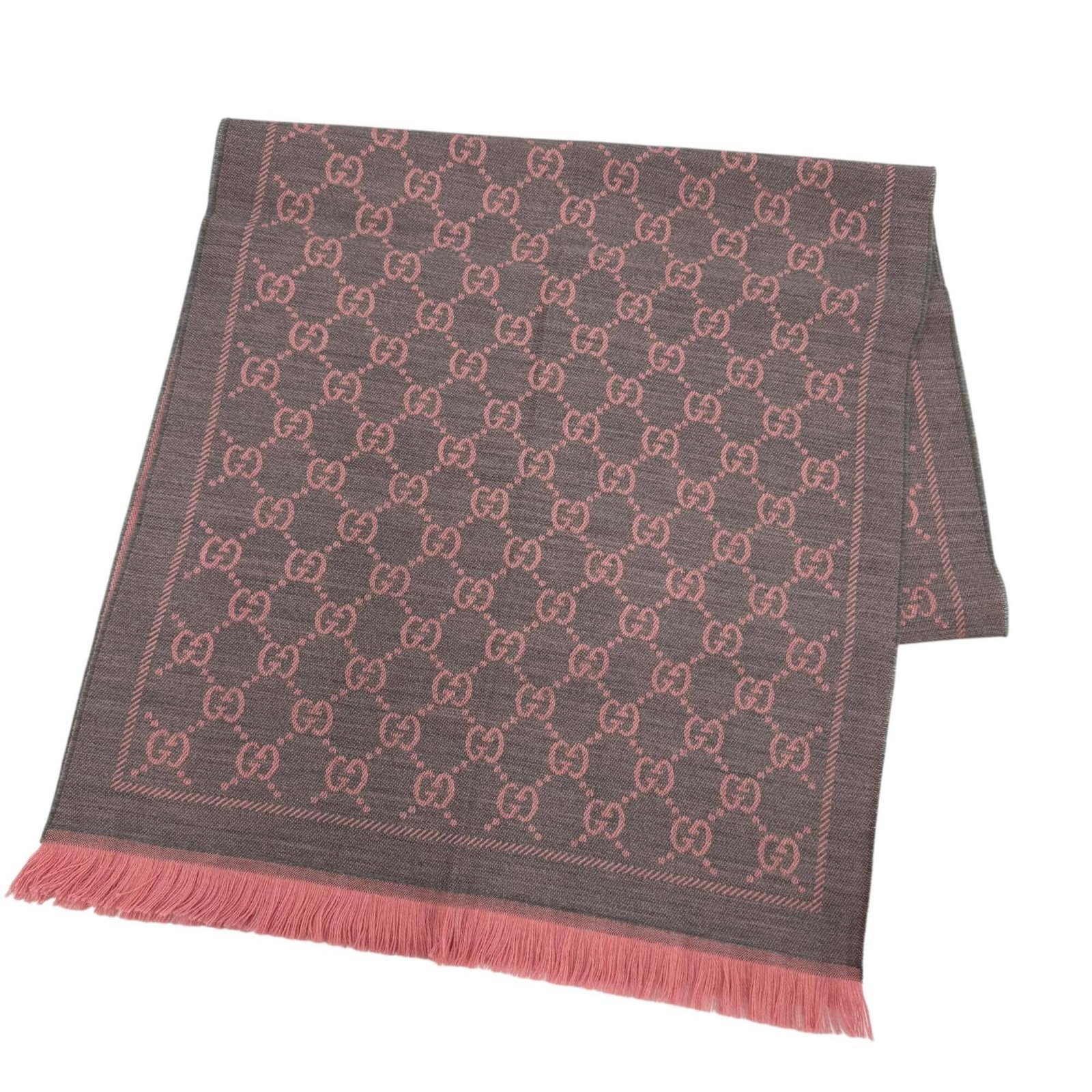Shawl wool from Gucci: Shawl wool from Gucci Shawl made from luxurious Gucci wool, available in a striking gray and pink color combination. Measuring 69.68'' x 19.29'', this shawl boasts a unique size that sets it apart fro