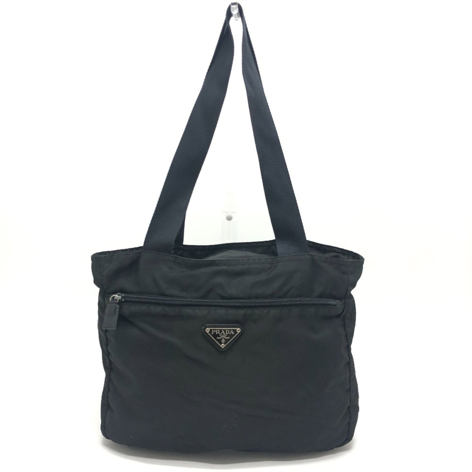 Nylon bag tote by Prada: Nylon bag tote by Prada Nylon bag tote by Prada, featuring a sleek black design and durable nylon material. Measuring 26cm x 32cm x 10cm, this shoulder bag tote has a compact size with a sturdy build.