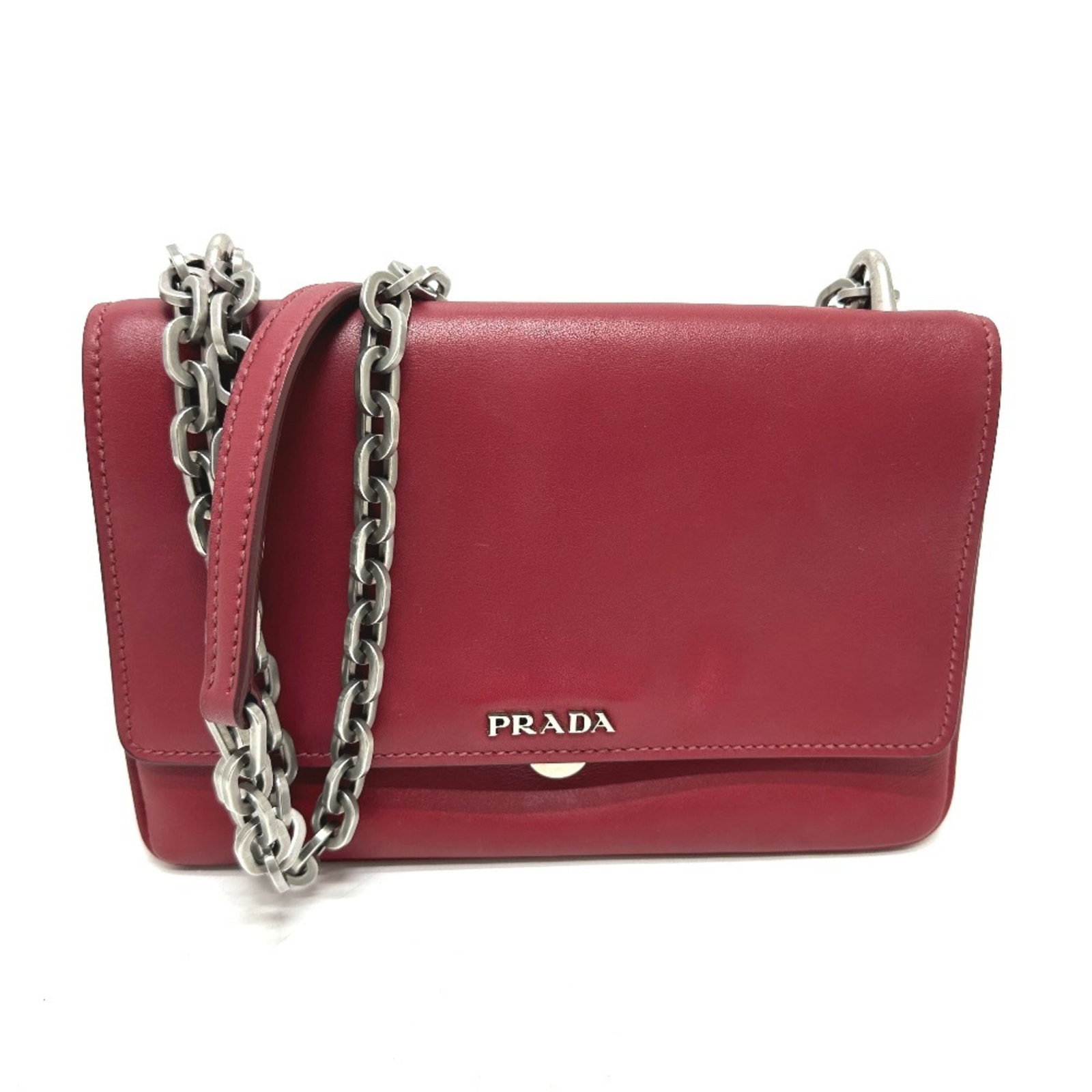 Prada Shoulder Bag Leather: Prada Shoulder Bag Leather The Prada Shoulder Bag Leather is a striking red leather shoulder bag with clean lines and classic design. Made from high-quality leather, its compact size (16cm x 19cm x