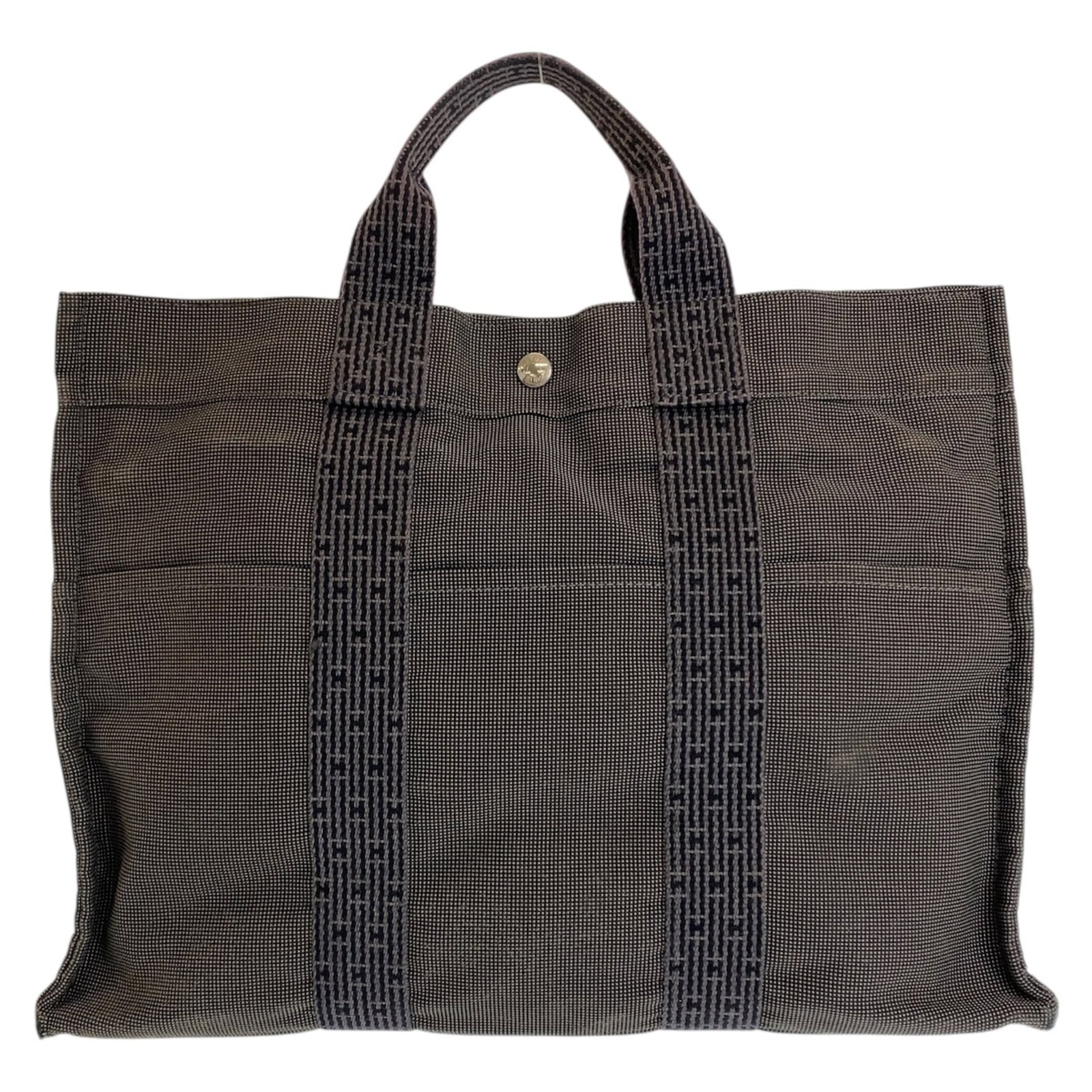Canvas tote bag handbag Hermes: Canvas tote bag handbag Hermes Canvas tote bag handbag from Hermes, made in France with canvas material and featuring a gray color. This versatile tote measures 32cm x 42cm x 10cm, making it a practic