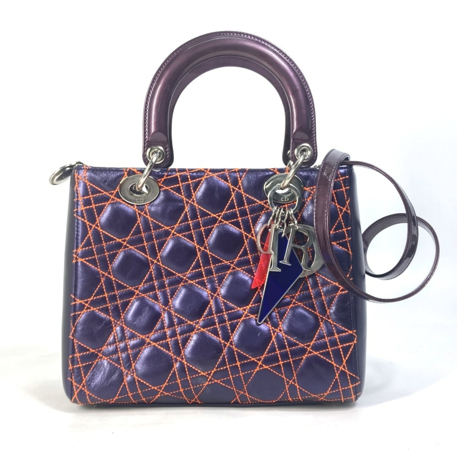 Christian Dior Leather Shoulder Bag: Christian Dior Leather Shoulder Bag The Christian Dior Leather Shoulder Bag boasts a vibrant orange and purple color combination, adding a pop of personality to any outfit. Made from high-quality