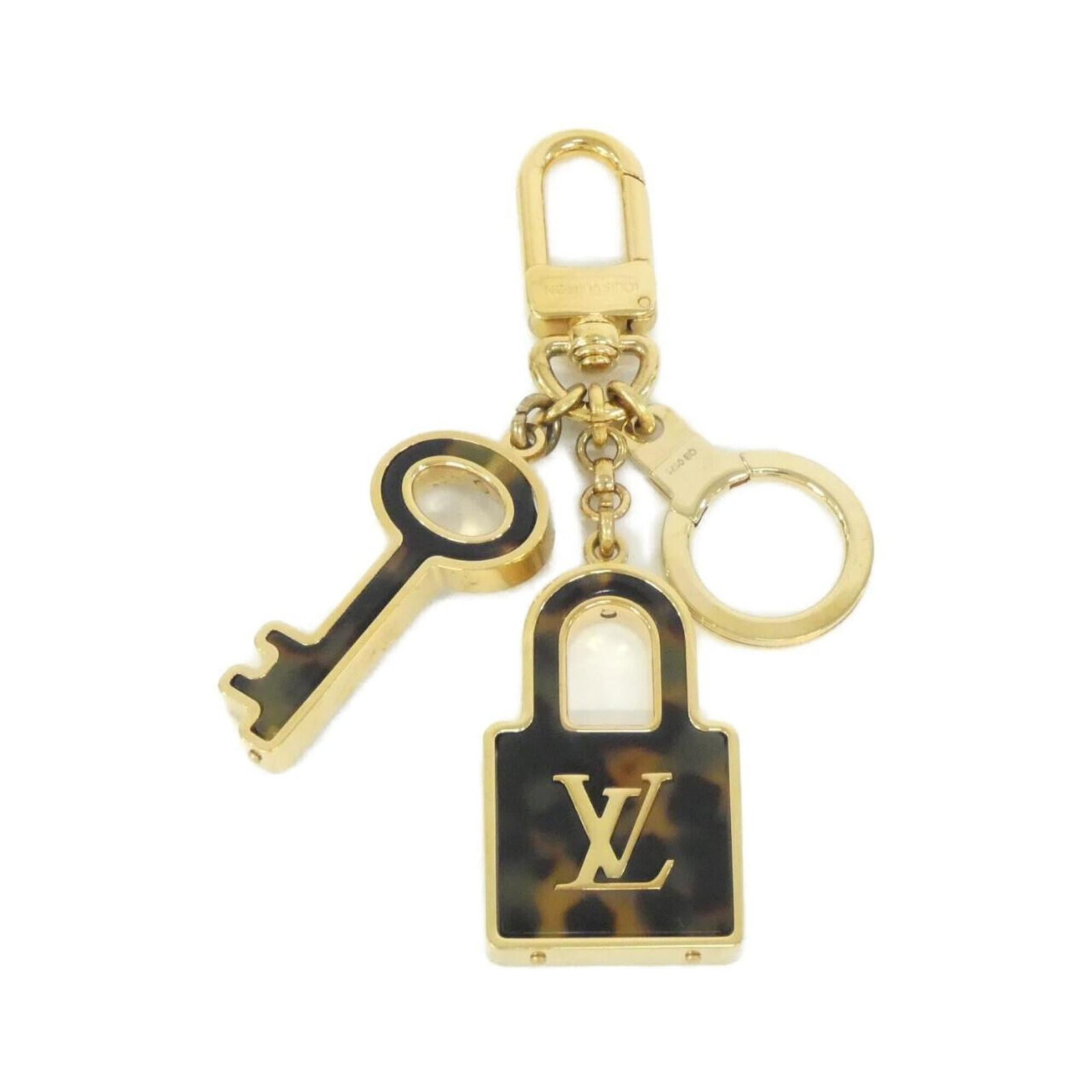Louis Vuitton Keyring: Louis Vuitton Keyring Brown and gold Louis Vuitton keyring, bearing the iconic monogram pattern. This stylish accessory features a classic design with a timeless appeal. Made from high-quality