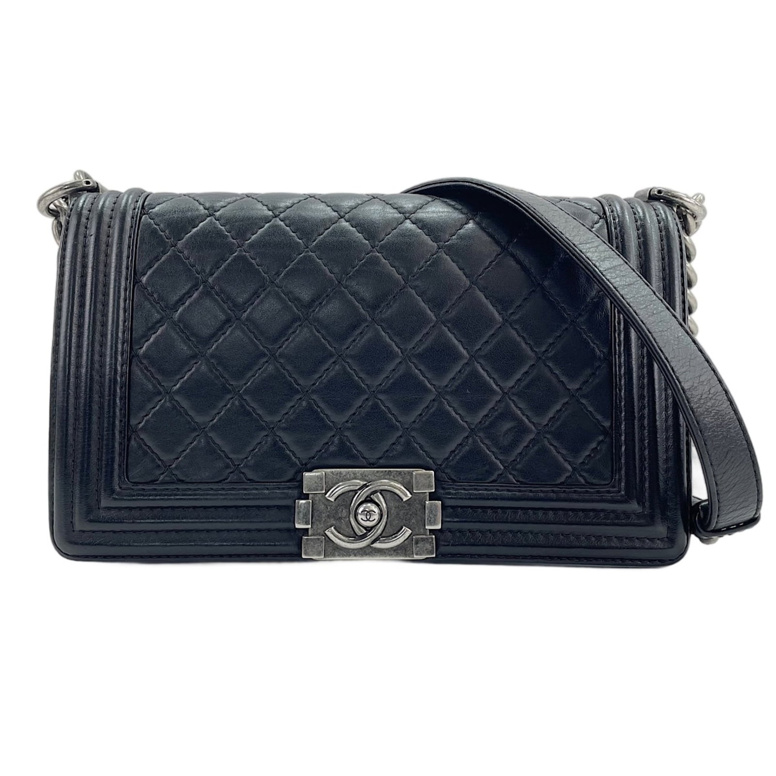 Leather Chanel Shoulder Bag: Leather Chanel Shoulder Bag Black leather shoulder bag from the Boy Chanel line, measuring 15cm x 24.5cm x 7cm and featuring adjustable straps that range from 100cm to 106cm in length. The bag is
