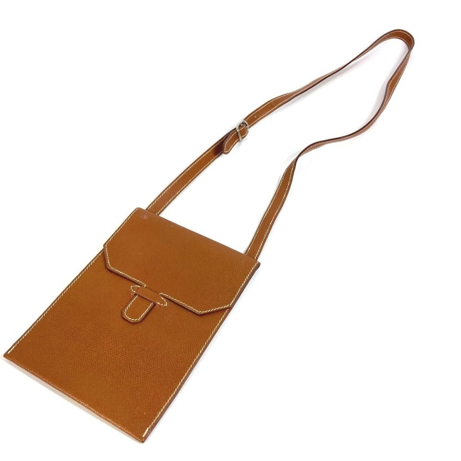 Hermes Pochette Shoulder Bag Leather: Hermes Pochette Shoulder Bag Leather Brown leather Pochette shoulder bag from Hermes, measuring 13.5cm x 8.5cm / 5.31'' x 3.34''. Made from high-quality leather, this classic design is a timeless acce