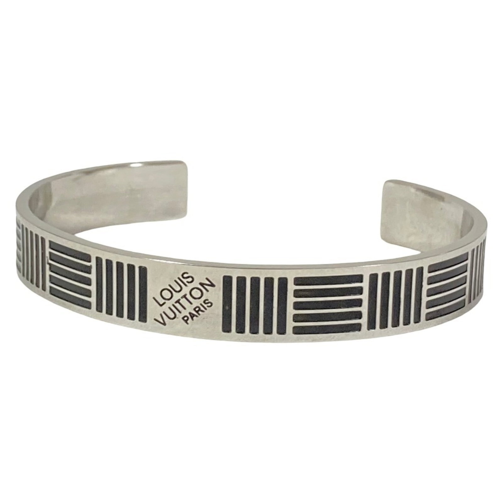 Louis Vuitton Bangle: Louis Vuitton Bangle Black Louis Vuitton bangle with silver details, measuring 18cm in length. This bangle features the iconic Louis Vuitton design, adding a touch of luxury to any outfit. The sleek