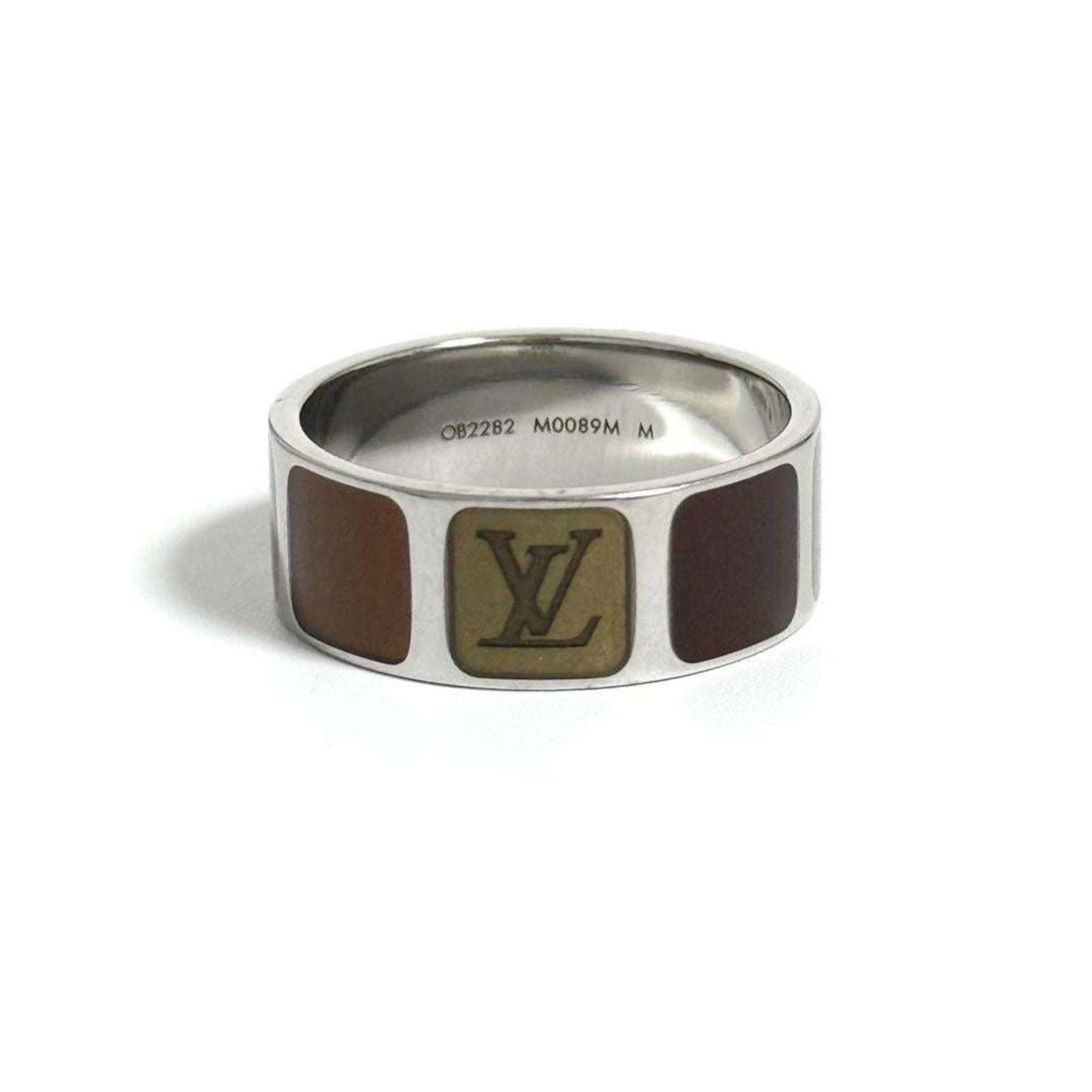 Louis Vuitton Band Ring Metal: Louis Vuitton Band Ring Metal Brown metal band ring from Louis Vuitton, available in US size 10. This metal band ring features the iconic brand's signature style and design. Made from high-quality met