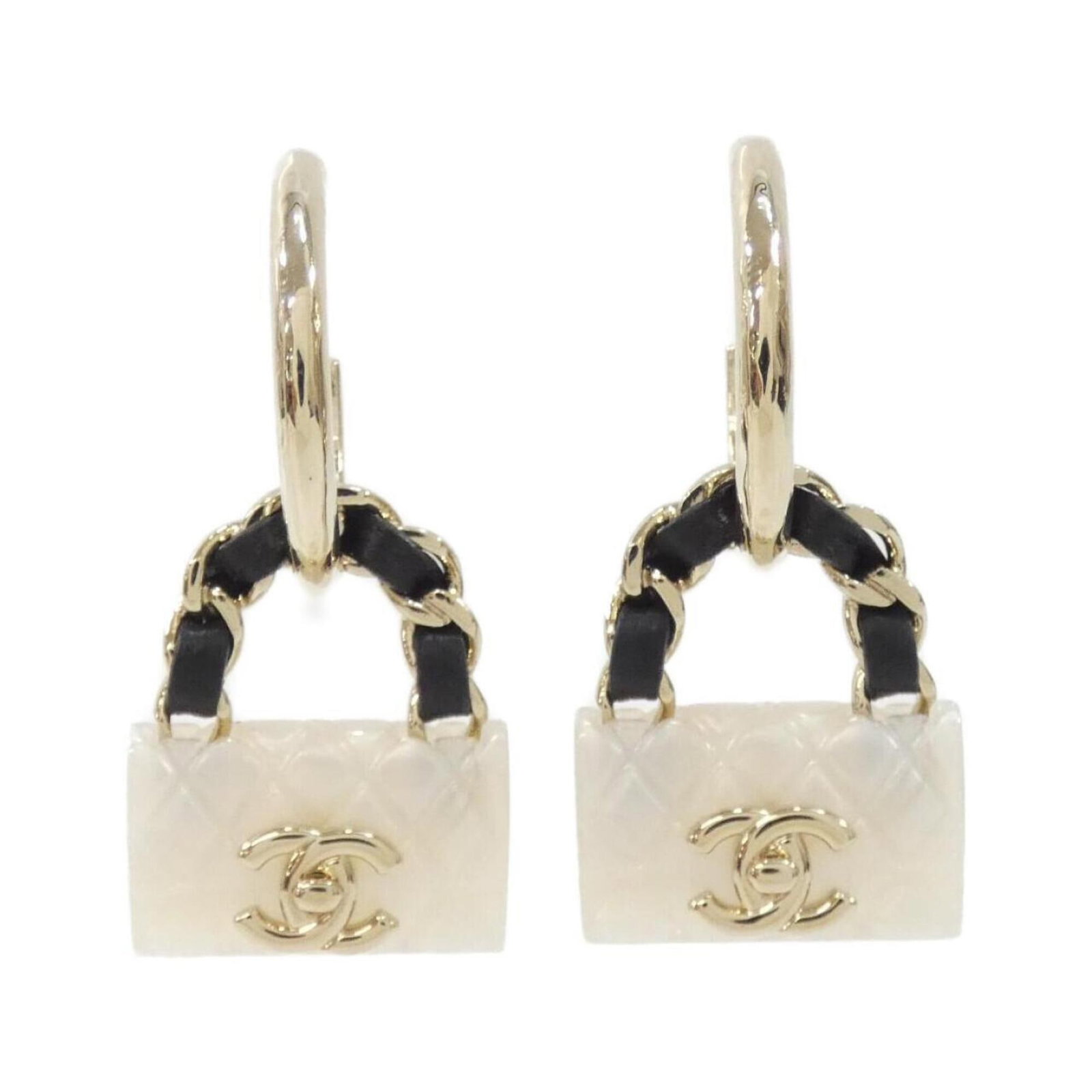 Stud earrings leather by Chanel: Stud earrings leather by Chanel Stud earrings from the iconic Chanel brand, crafted in high-quality leather. The sleek design features a classic stud style with a subtle black and white color palette,