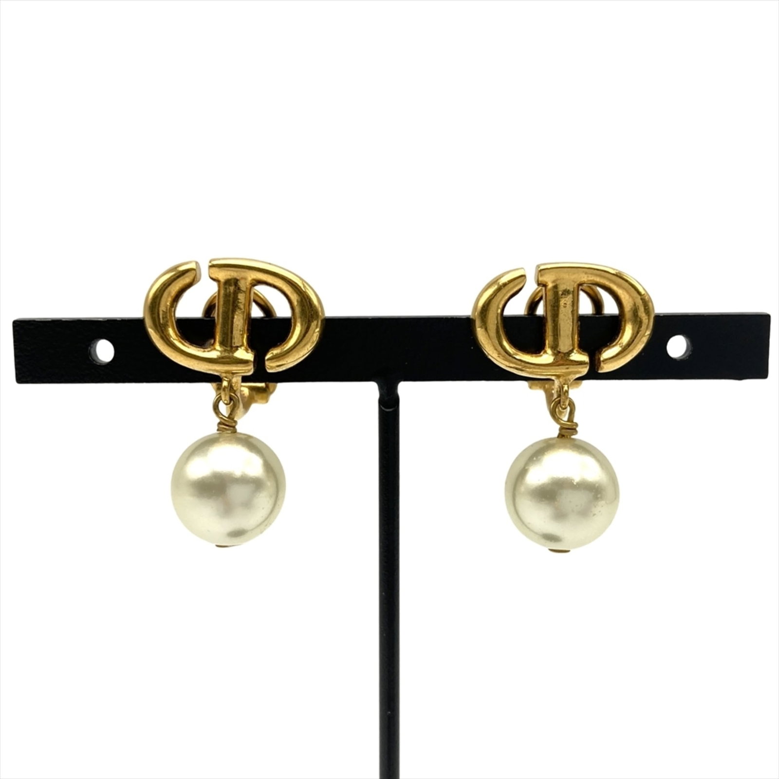 Metal clip earrings by Christian Dior: Metal clip earrings by Christian Dior Metal clip earrings by Christian Dior, featuring gold metal and artificial pearl details. Made with precision engineering, these elegant earrings showcase the ico
