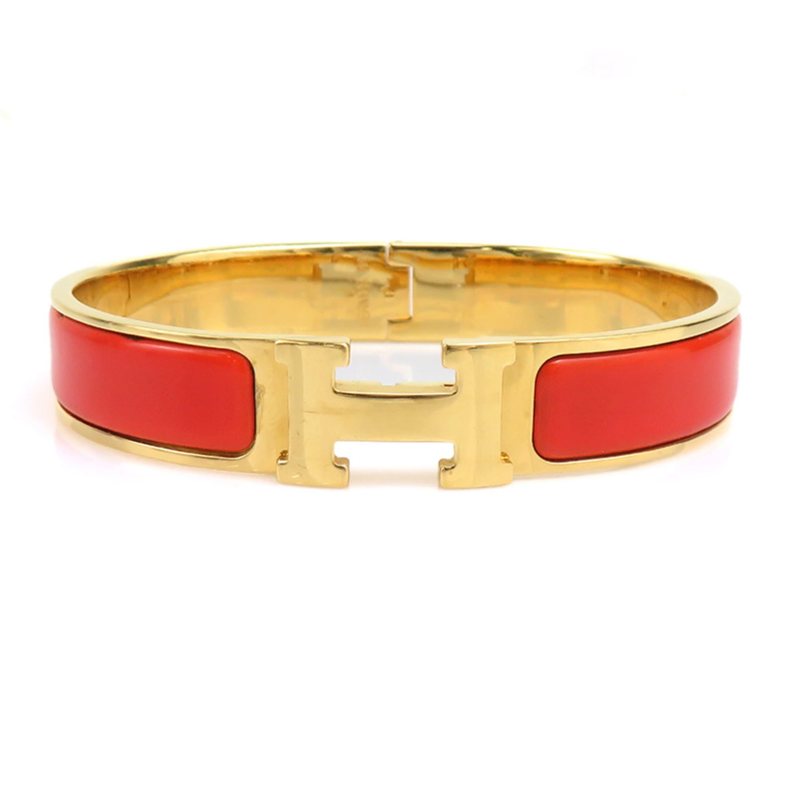 Hermes Bangle Enamel Metal: Hermes Bangle Enamel Metal Gold and orange enamel metal bangle from Hermes, measuring 17cm in length. This bangle showcases the iconic color combination characteristic of Hermes' design style. Made fr