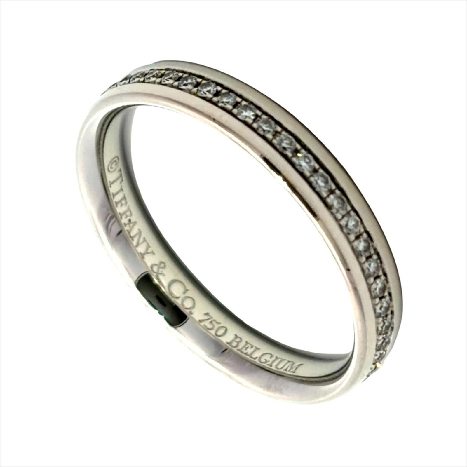 White Gold Tiffany Band Ring 18K: White Gold Tiffany Band Ring 18K 18K white gold band ring from Tiffany's Metro line, featuring a diamond stone and sleek design. The ring boasts a classic look with its simple yet elegant style. Weigh