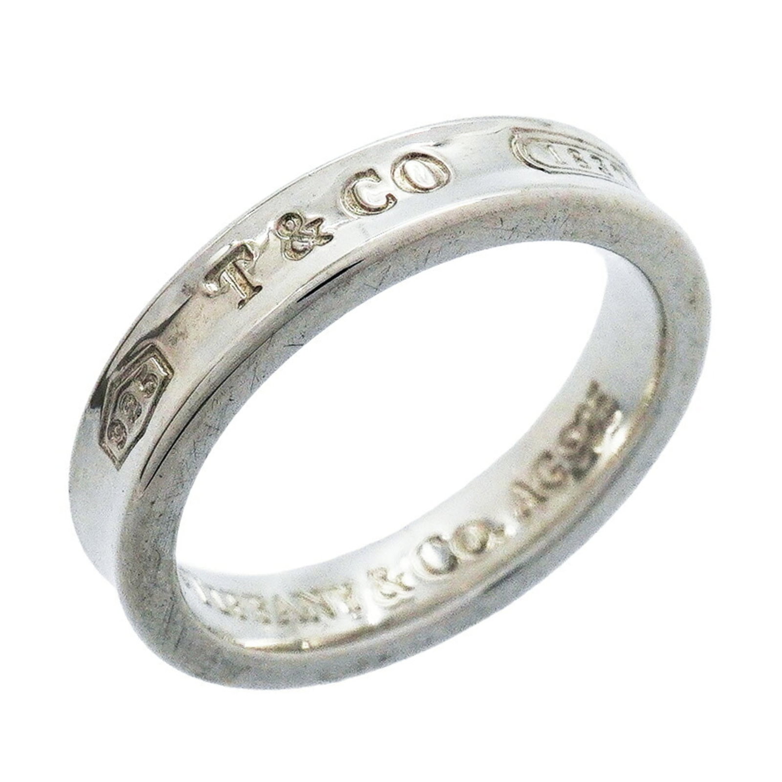 Silver Ring Band Tiffany: Silver Ring Band Tiffany Silver Ring Band Tiffany, US Size 5. This sterling silver band ring features the iconic Tiffany brand and is made from high-quality 925 silver. A classic and elegant design