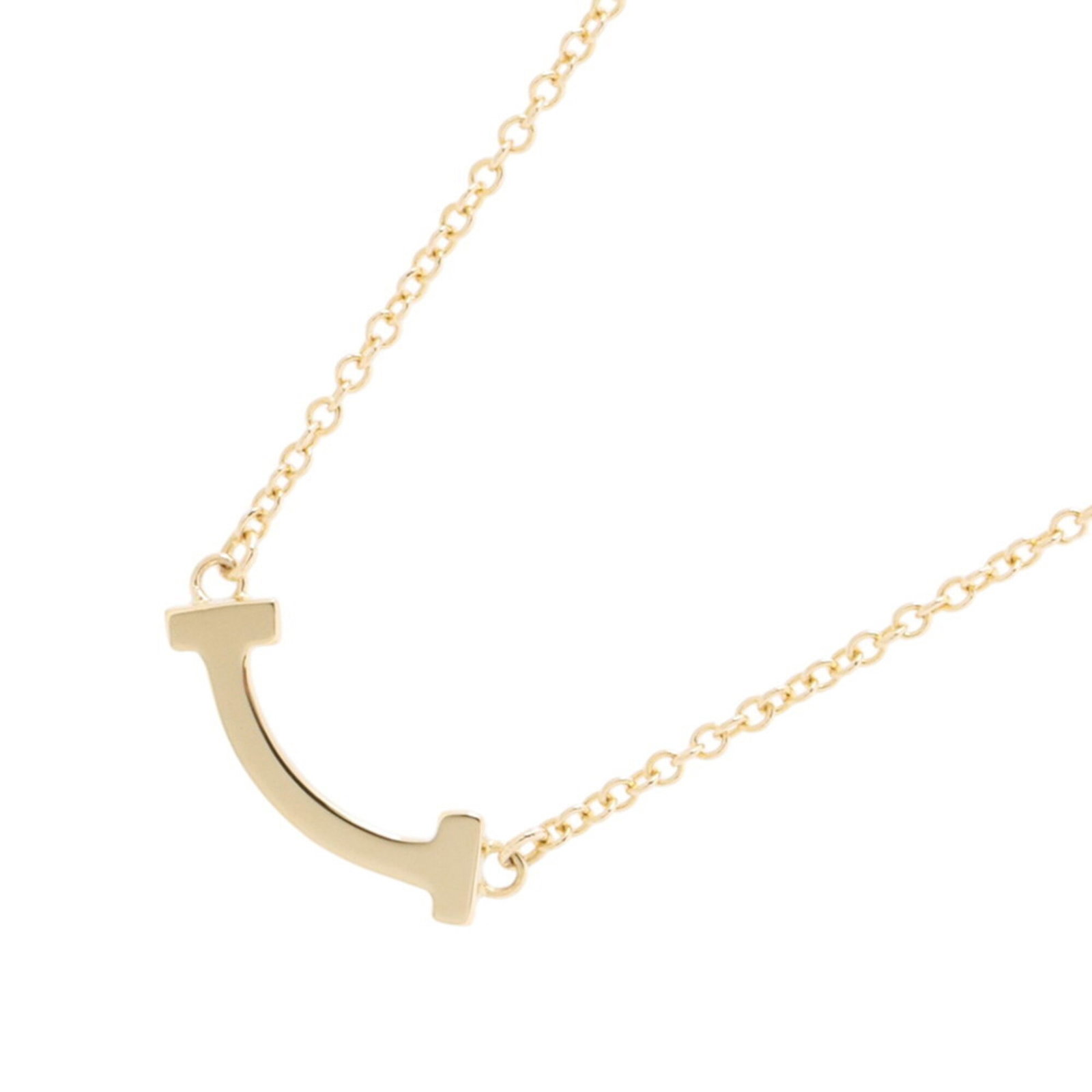 Tiffany & Co. T Smile Necklace Mini Pendant 18K Yellow Gold 62617640.: Tiffany & Co. T Smile Necklace Mini Pendant 18K Yellow Gold 62617640. Tiffany & Co. T Smile Necklace Mini Pendant 18K Yellow Gold - A delicate 3.6mm x 13.3mm pendant in 18K yellow gold, featuring the 