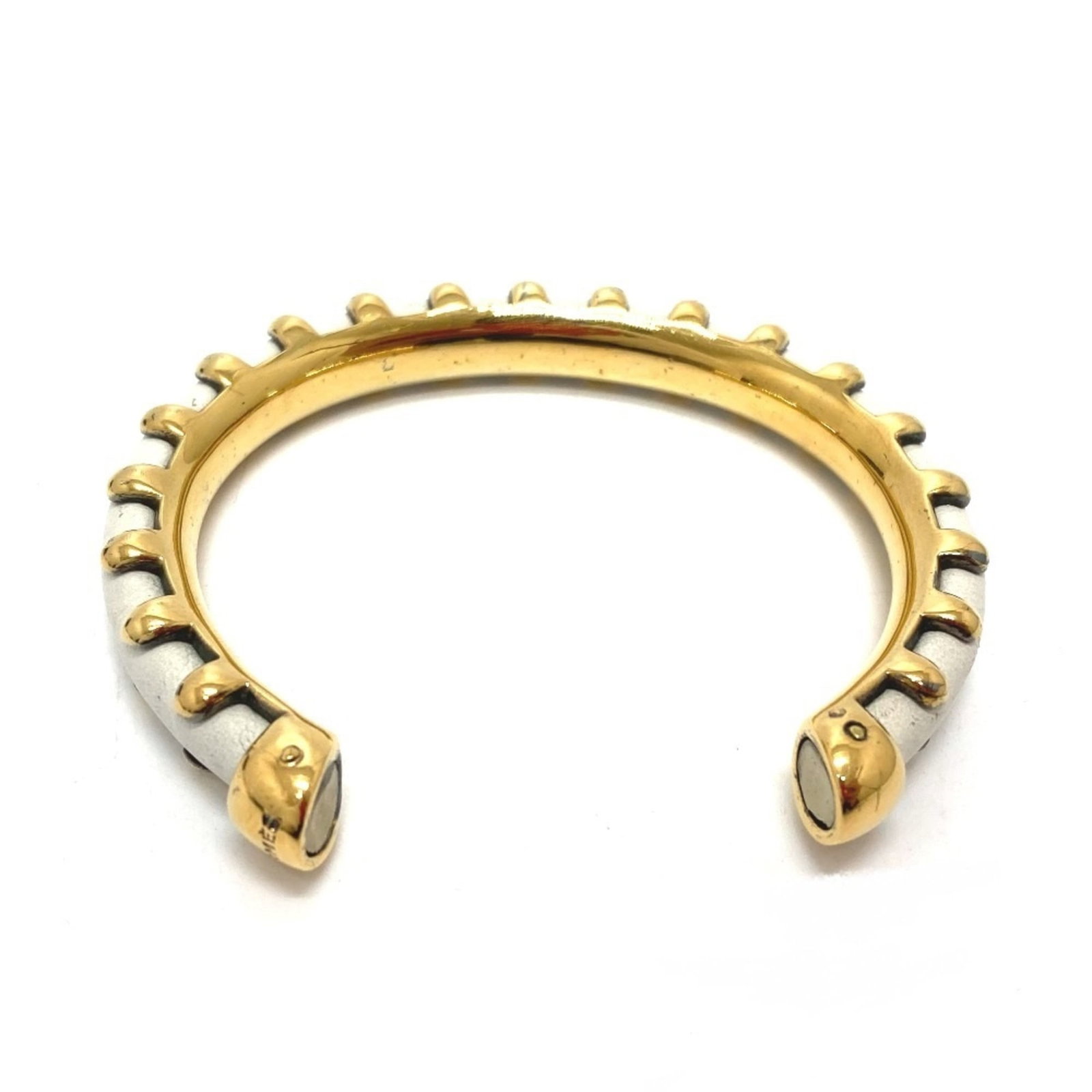 Metal Leather Charm Hermes Bracelet: Metal Leather Charm Hermes Bracelet White metal and genuine leather come together in this sleek Hermes charm bracelet, measuring 17.2cm in length. The minimalist design showcases the quality of the ma