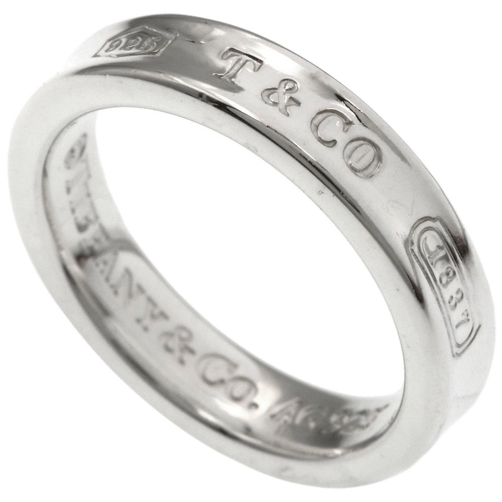 Silver Ring Tiffany Band: Silver Ring Tiffany Band Silver Ring Tiffany Band, US Size 4.5, crafted from high-quality silver material, features a classic band design. This elegant ring boasts a timeless style that suits women's 