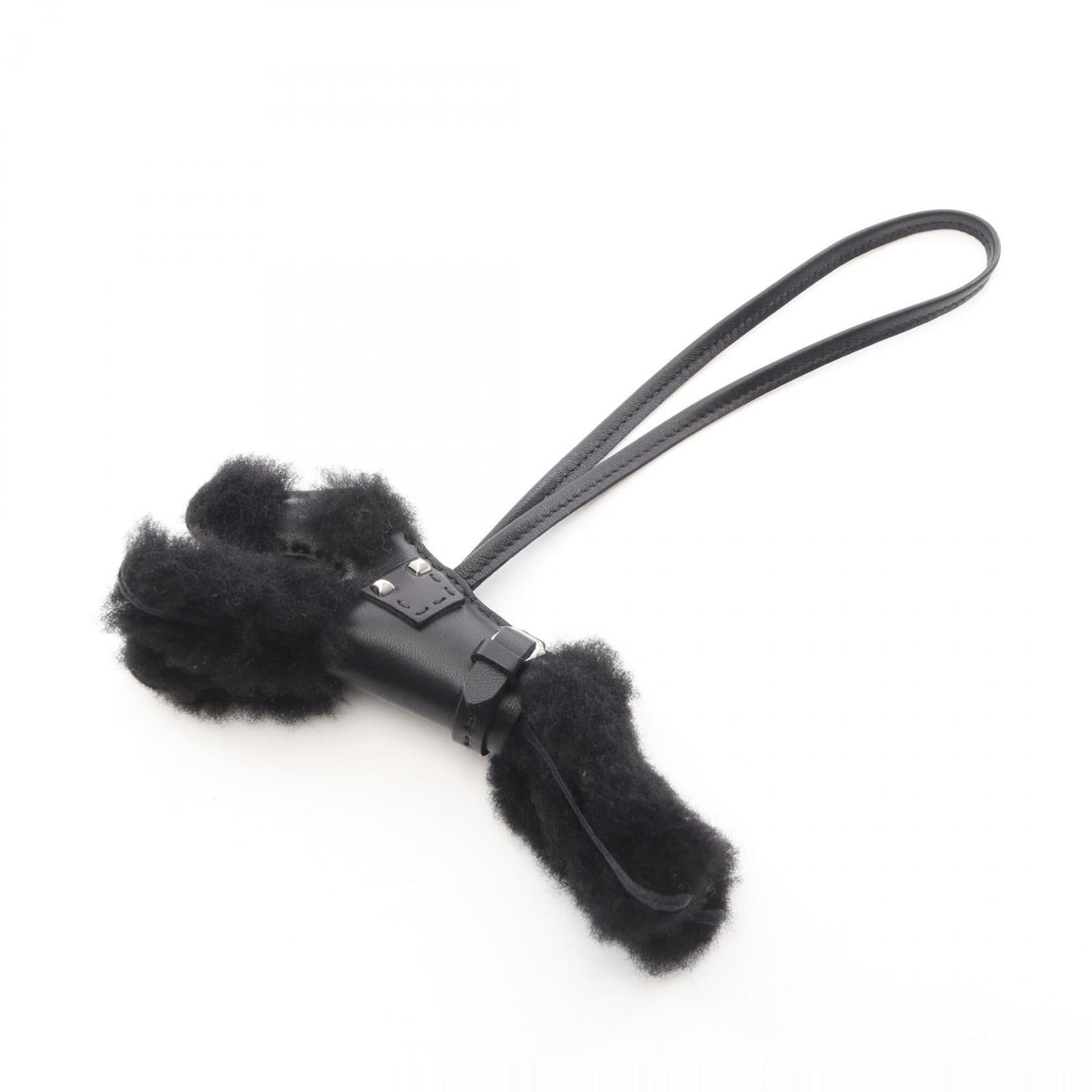 Agneau Handbag Charm Hermes: Agneau Handbag Charm Hermes Agneau Handbag Charm by Hermes features an agneau (goat) design in black. This charm is made from Milo, a material known for its durability and versatility. The distinctive
