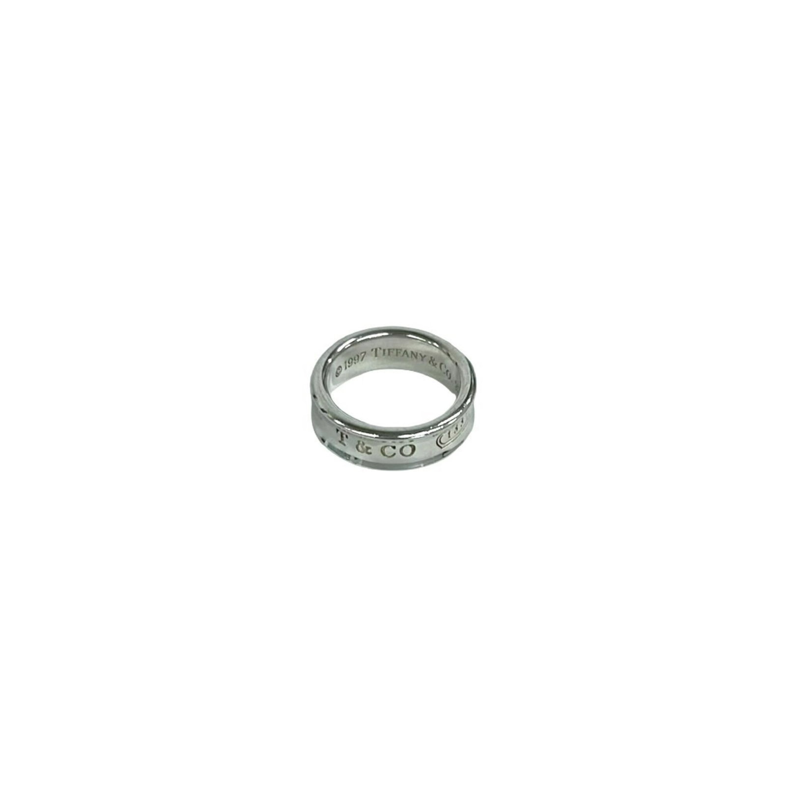 Silver Ring Band Tiffany: Silver Ring Band Tiffany Silver Ring Band Tiffany, US Size 6. A sterling silver band ring with a classic design from the iconic brand Tiffany. Made from high-quality silver material (925), this elegan
