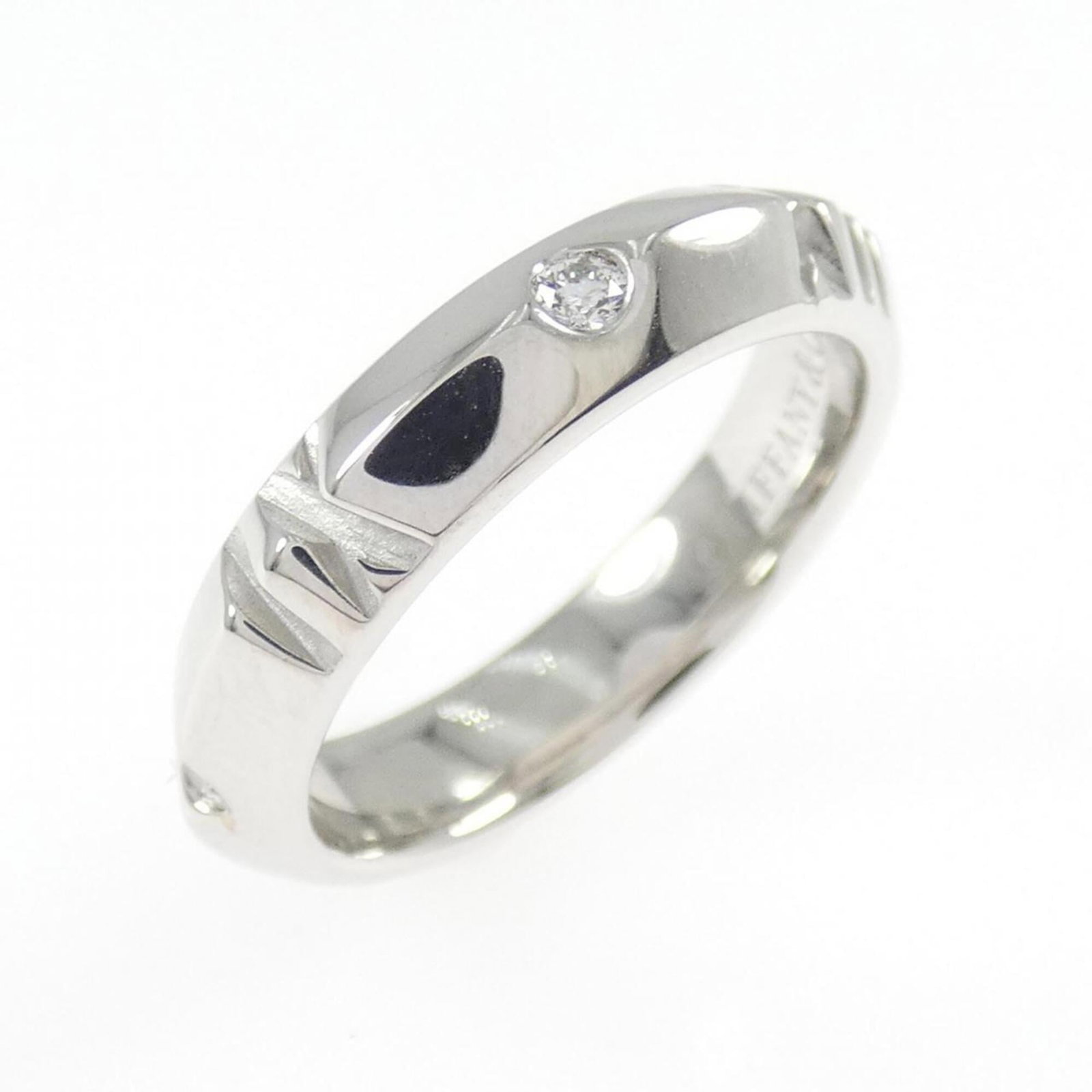 White Gold Tiffany Band Ring 18K: White Gold Tiffany Band Ring 18K 18K white gold band ring from Tiffany Line features a diamond weighing 0.10 carats, set in a sturdy design with a US size 5 fit and a width of 4.1mm. The ring's weight
