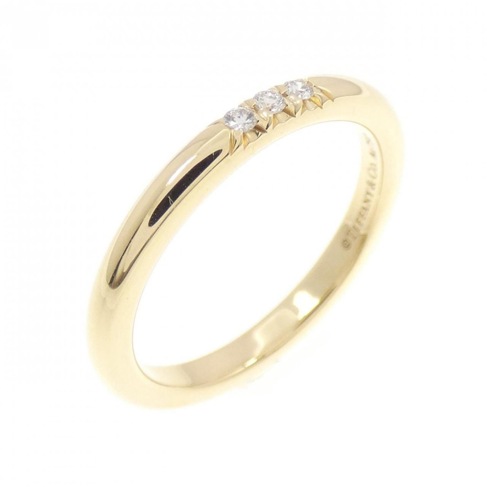 Tiffany ring gold 18k yellow band: Tiffany ring gold 18k yellow band 18k yellow gold band from Tiffany, featuring a diamond stone and US size 3.5. This classic ring showcases the iconic brand's signature style with its simple yet