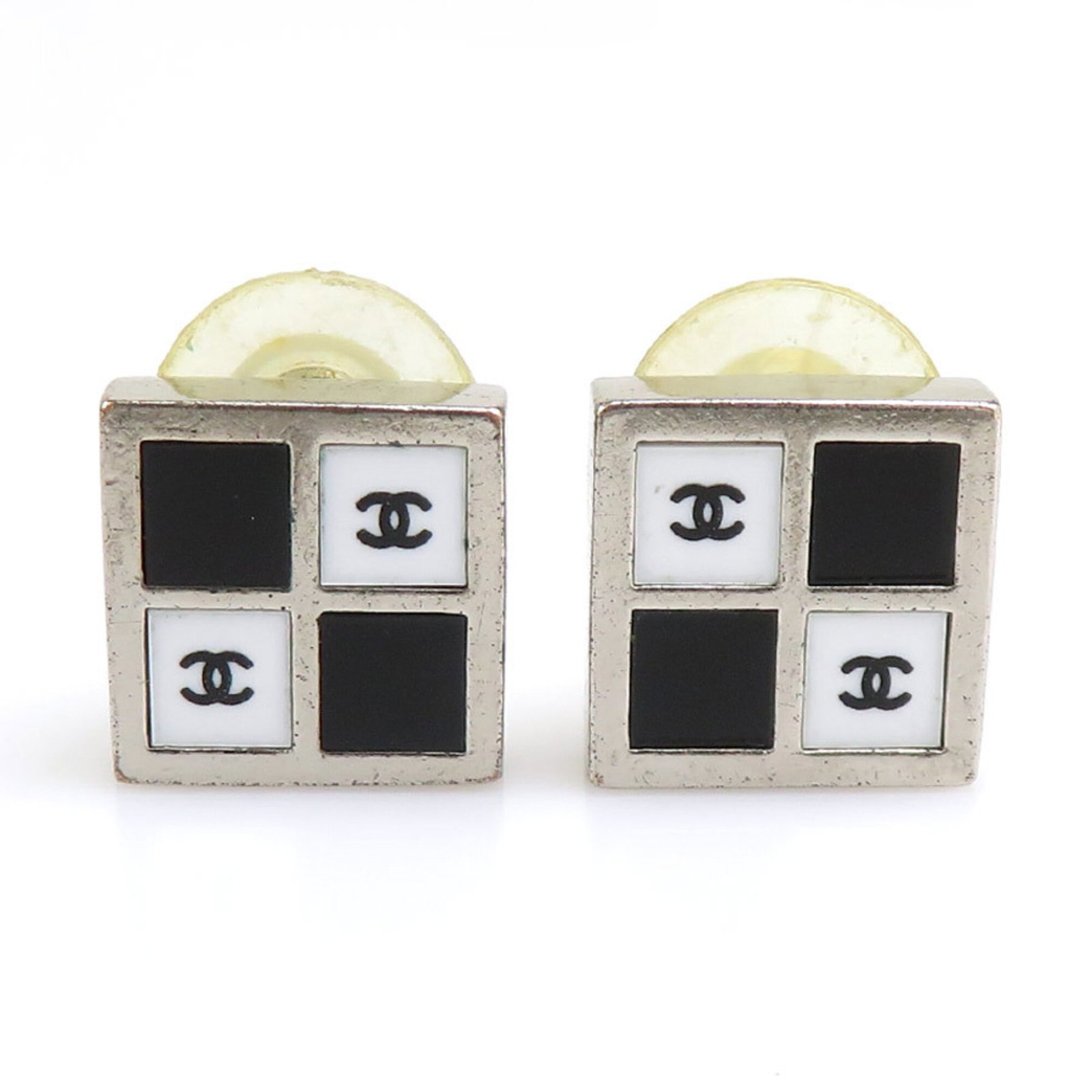 Metal stud earrings by Chanel: Metal stud earrings by Chanel Metal stud earrings by Chanel, crafted from high-quality metal and available in black, silver, and white finishes. Measuring 15mm x 15mm, these sleek earrings are a class