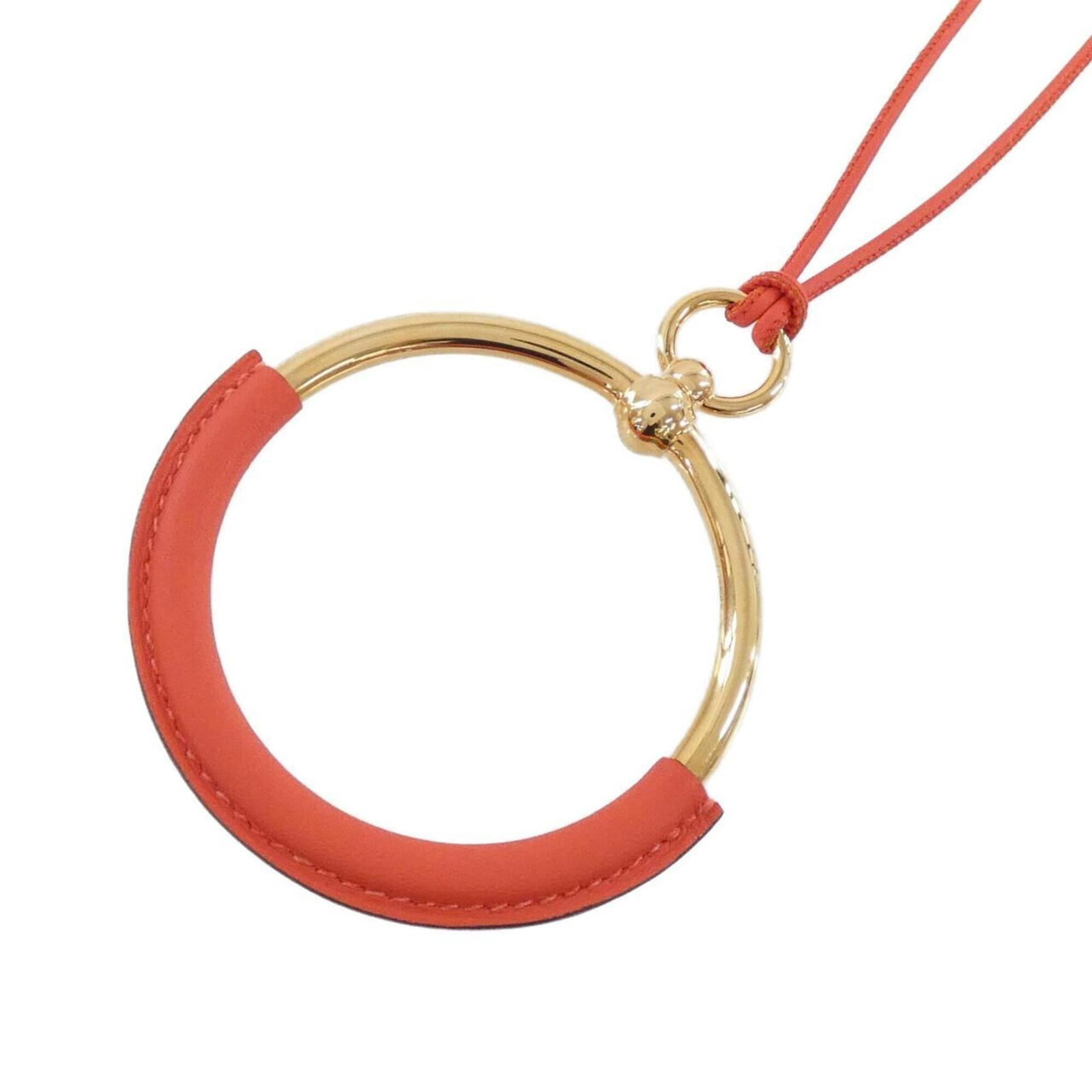 Hermes Loop 072933Cd Necklace: Hermes Loop 072933Cd Necklace Swift leather necklace with an orange and rose gold pendant, measuring 70mm x 75mm. The necklace features a unique design with a notable signature. Measuring 80 cm in
