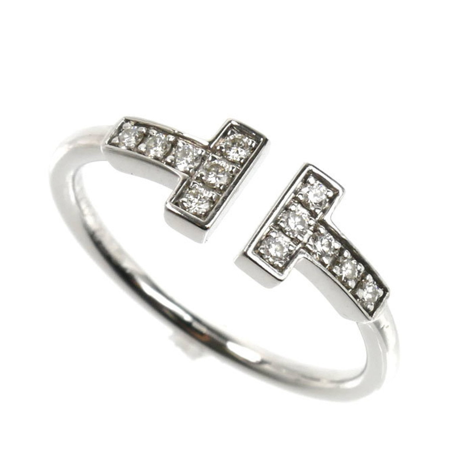 White Gold Tiffany Band Ring 18K: White Gold Tiffany Band Ring 18K White gold Tiffany band ring in 18K, bearing a signature, features a diamond stone and is available in US size 6.5. This elegant ring showcases the luxury of Tiffany's